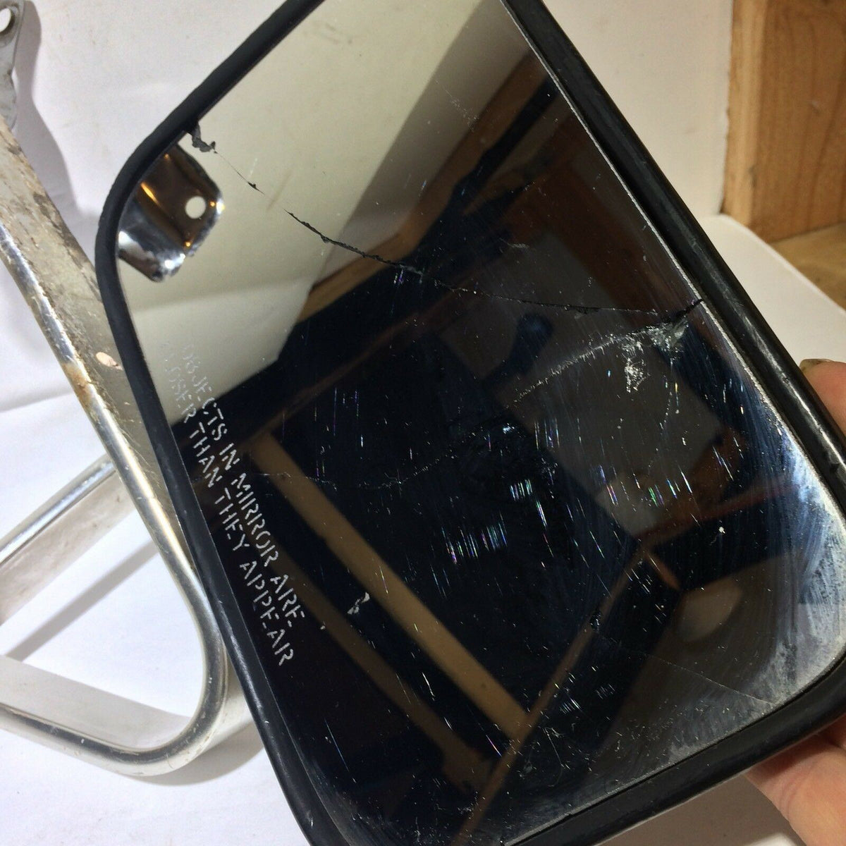 Pickup Truck Set of Side Manual Mirrors with Chrome & Metal Housing, showing a cracked and scratched mirror surface, highlighting the wear and age of the product.