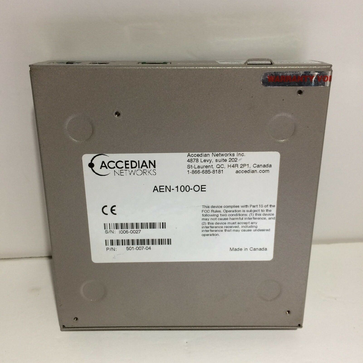 ACCEDIAN NETWORKS AEN-100-OE-Ethernid unit view, showcasing the back panel with labels and manufacturing details. Ideal for networking applications.