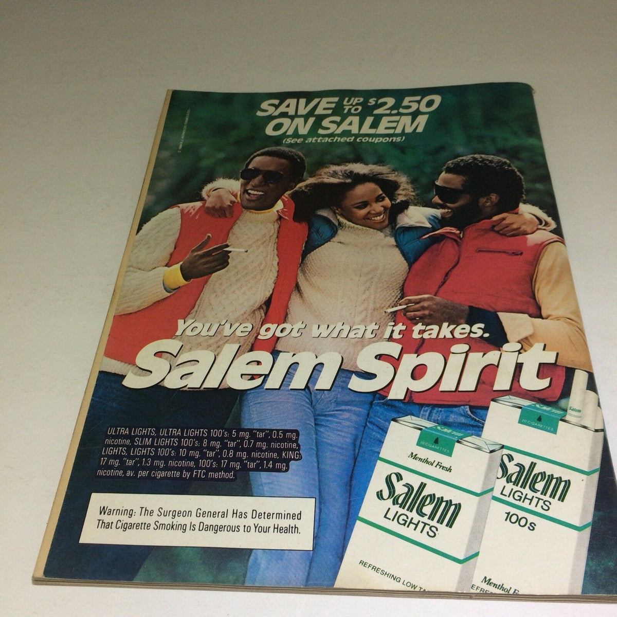 Vintage advertisement from the December 1984 'The Michael Jackson Nobody Knows' Ebony Magazine showcasing a group of three friends celebrating and smiling, promoting Salem cigarettes with the tagline 'You've got what it takes. Salem Spirit.' The ad captures the essence of early 80s pop culture.