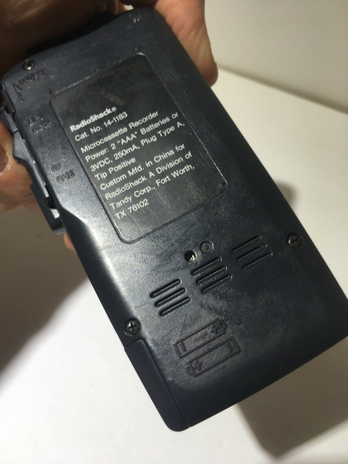 Close-up view of the back of the Radio Shack Micro-44 Micro Cassette Recorder, showcasing the model information and battery compartment, emphasizing its vintage audio technology and functional design.