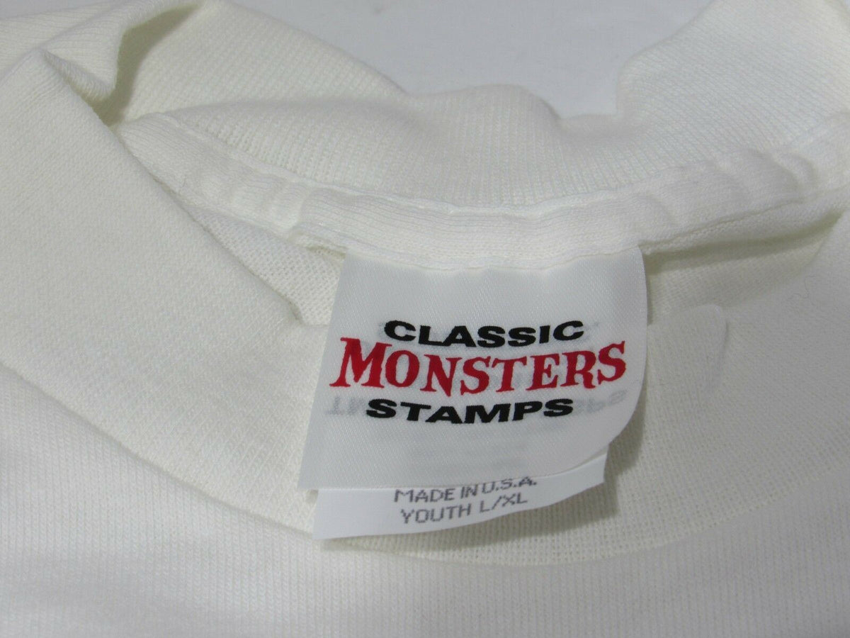 Tag of the Frankenstein Shirt Youth L/XL NEW Tee, showcasing the 'Classic Monsters Stamps' label, made in the USA for quality assurance.