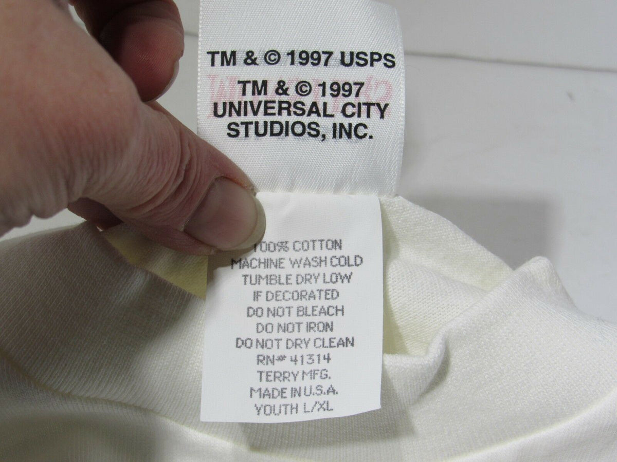 Label detail of a Frankenstein Shirt Youth L/XL NEW Tee featuring care instructions and manufacturer information, showcasing the classic monsters theme.