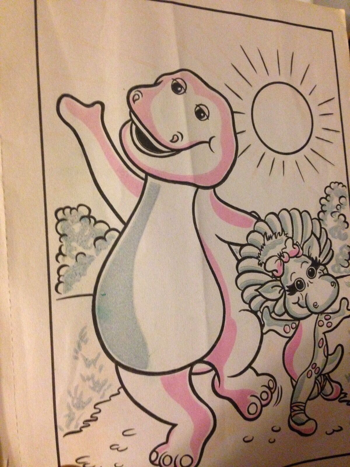 Black and white illustration from the Vintage 1993 Barney & Baby Bop Paint with Water Activity Book, featuring Barney and Baby Bop in a playful scene.
