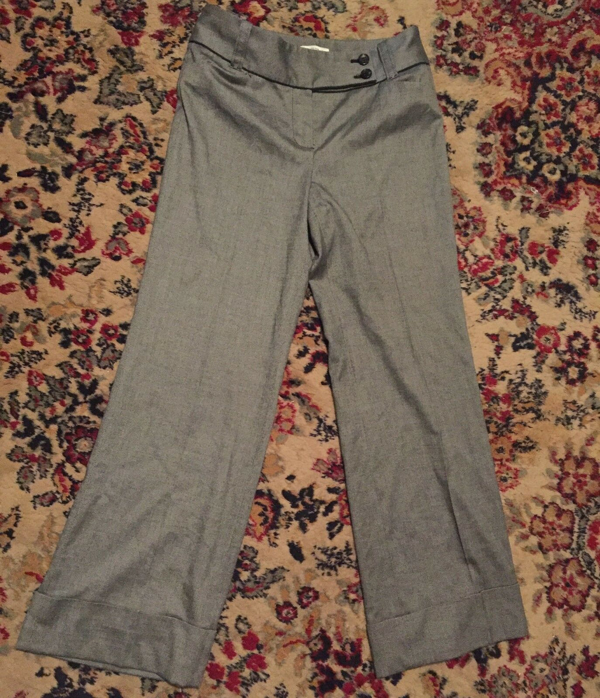 Ann Taylor Loft Women’s Dress Pants with wide cuff leg design in fine white and black pattern, displayed on a floral carpet.