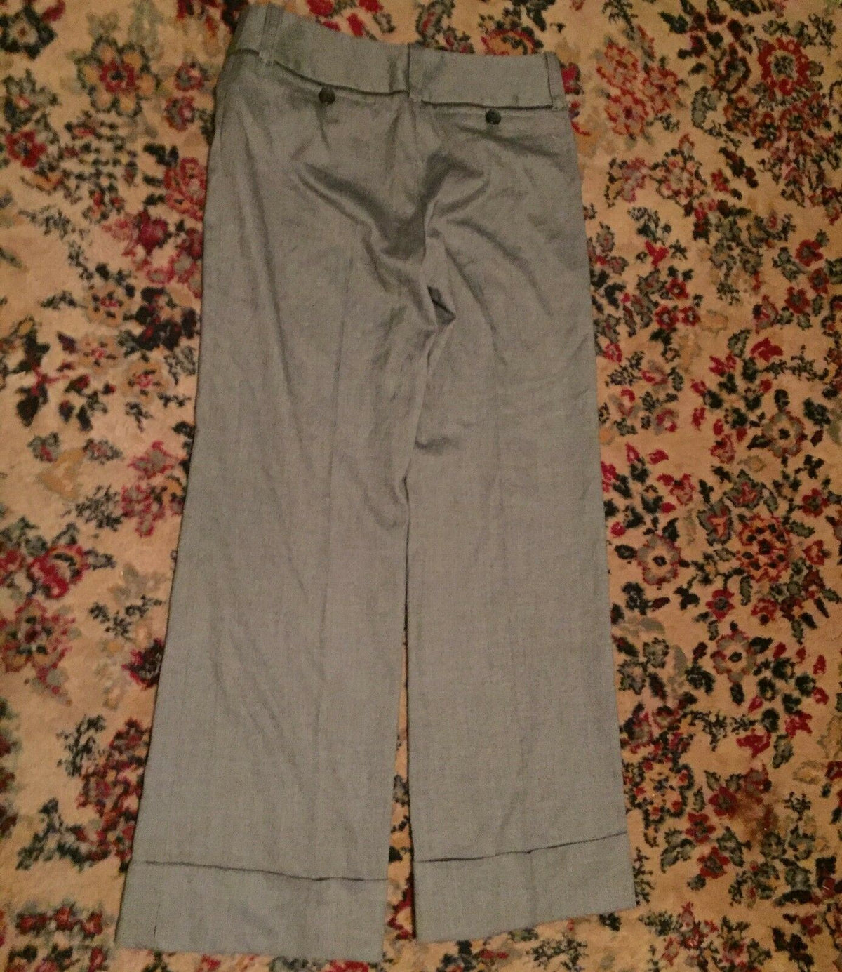 Full view of Ann Taylor Loft dress pants in wide cuff leg style, highlighting the elegant design and fabric of fine white and black pattern.