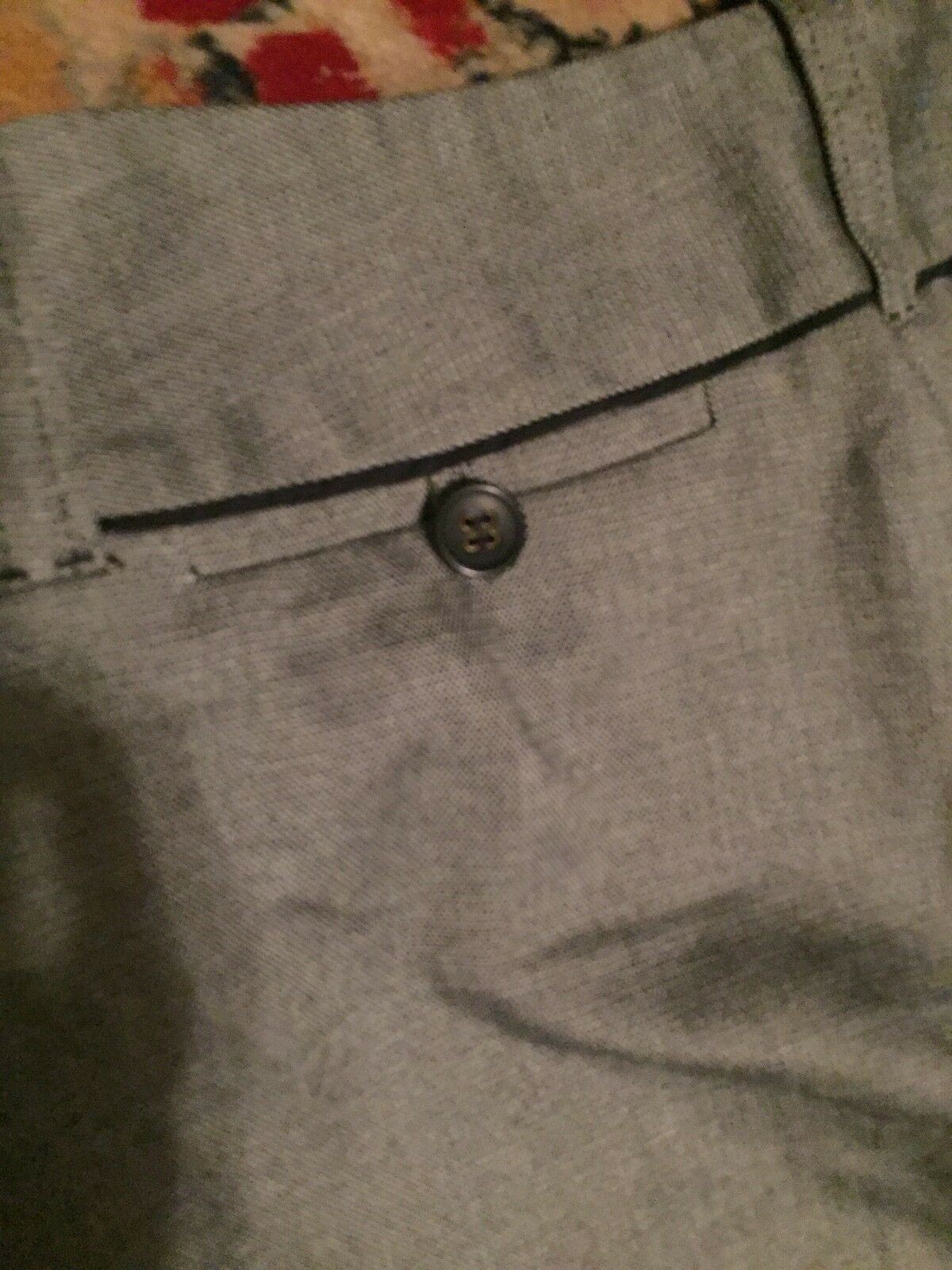 Detailed view of the back button closure on Ann Taylor Loft Women's Dress Pants, highlighting the stylish craftsmanship and vintage appeal.