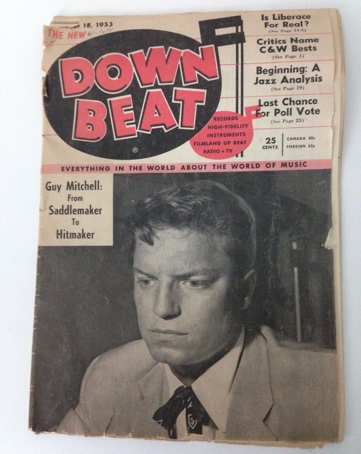 Vintage Down Beat Magazine cover from November 18, 1953 featuring Guy Mitchell, showcasing the title and elements such as Country + Western music, and highlights about Liberace.
