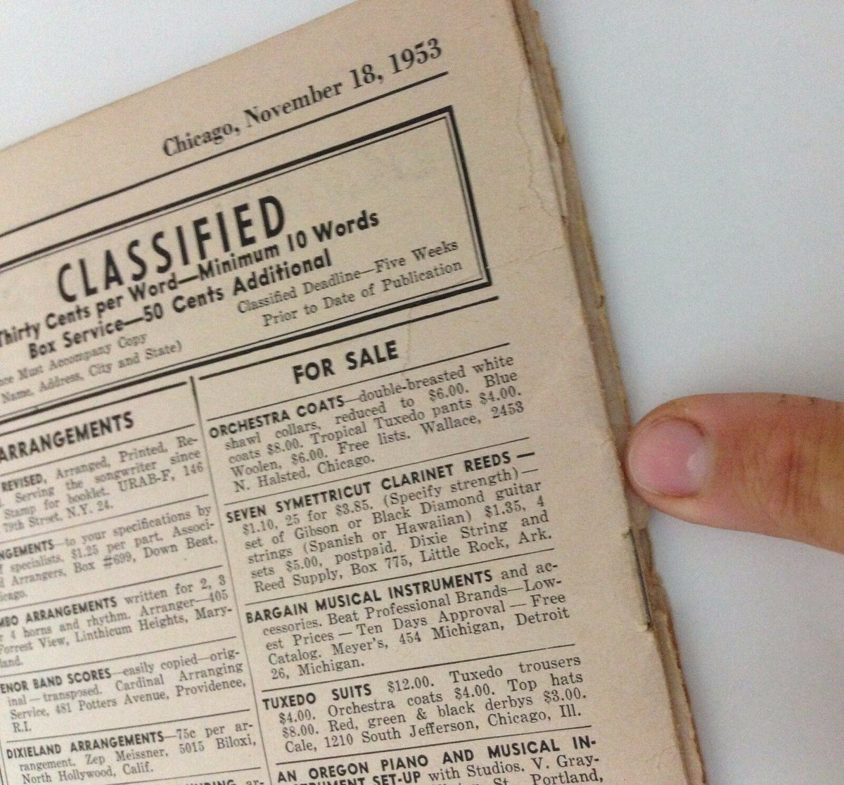 Classified section of Down Beat Magazine featuring listings from November 18, 1953, highlighting musical instruments and arrangements, part of the issue with Guy Mitchell and Liberace.