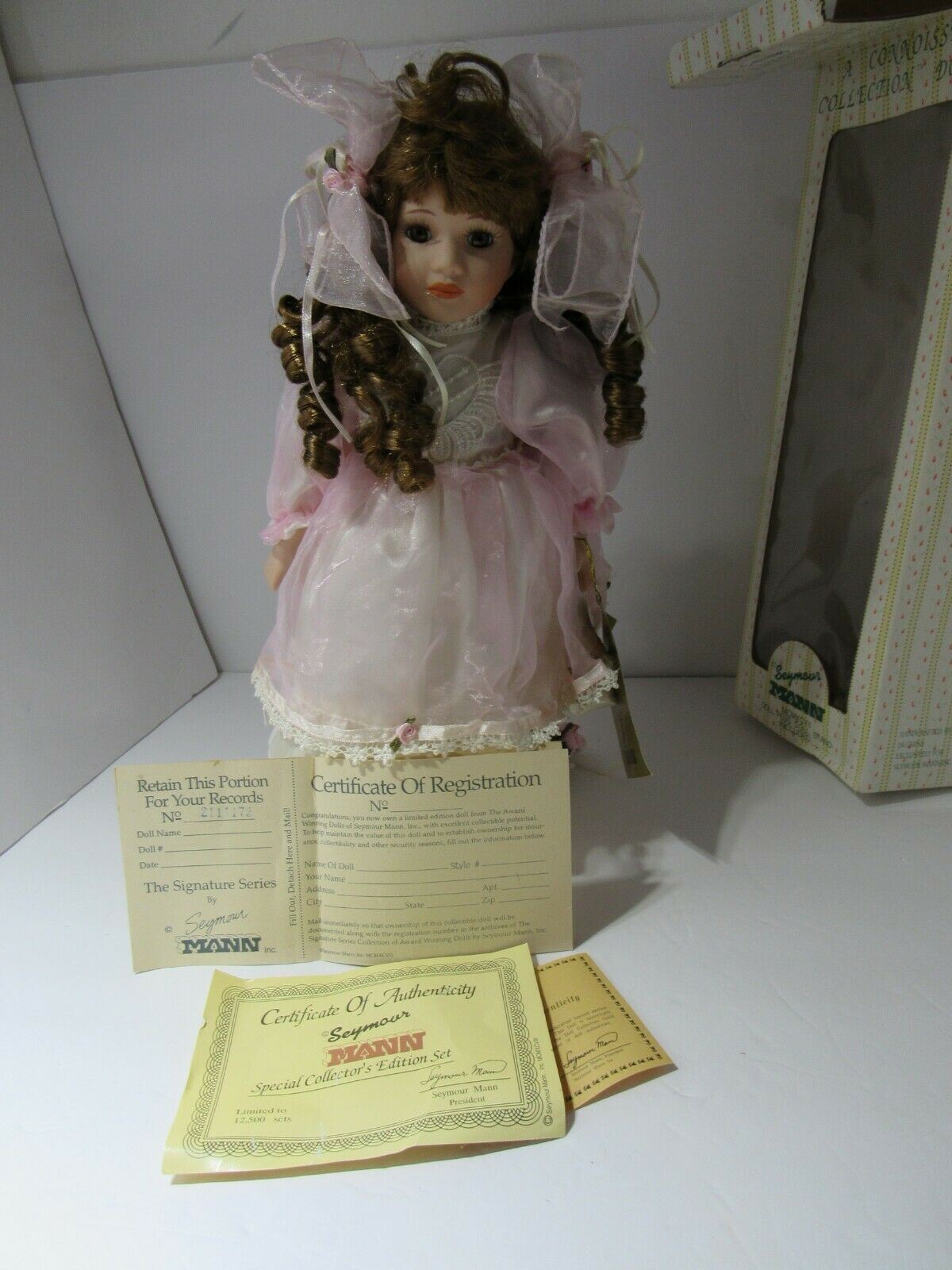 SEYMOUR MANN 'SALLY' Connoisseur Collection doll with registration certificates, displayed with the original box and stand included.