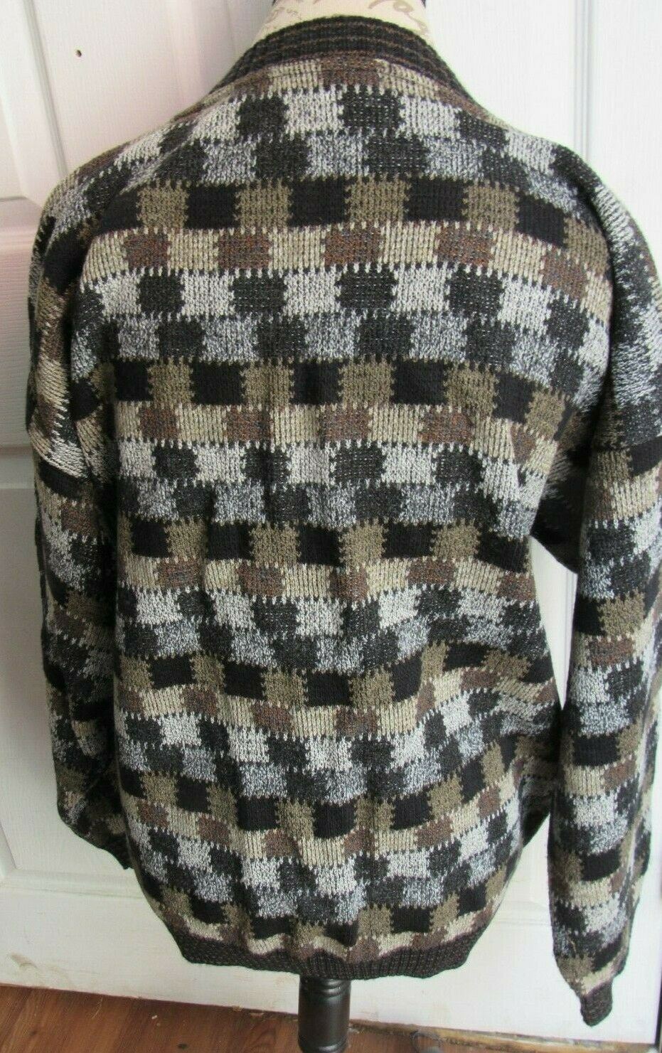 Back view of the Vintage 1990s Protege Collection Cardigan Sweater, emphasizing the detailed plaid pattern in shades of black and brown, displayed on a mannequin for visual appeal.