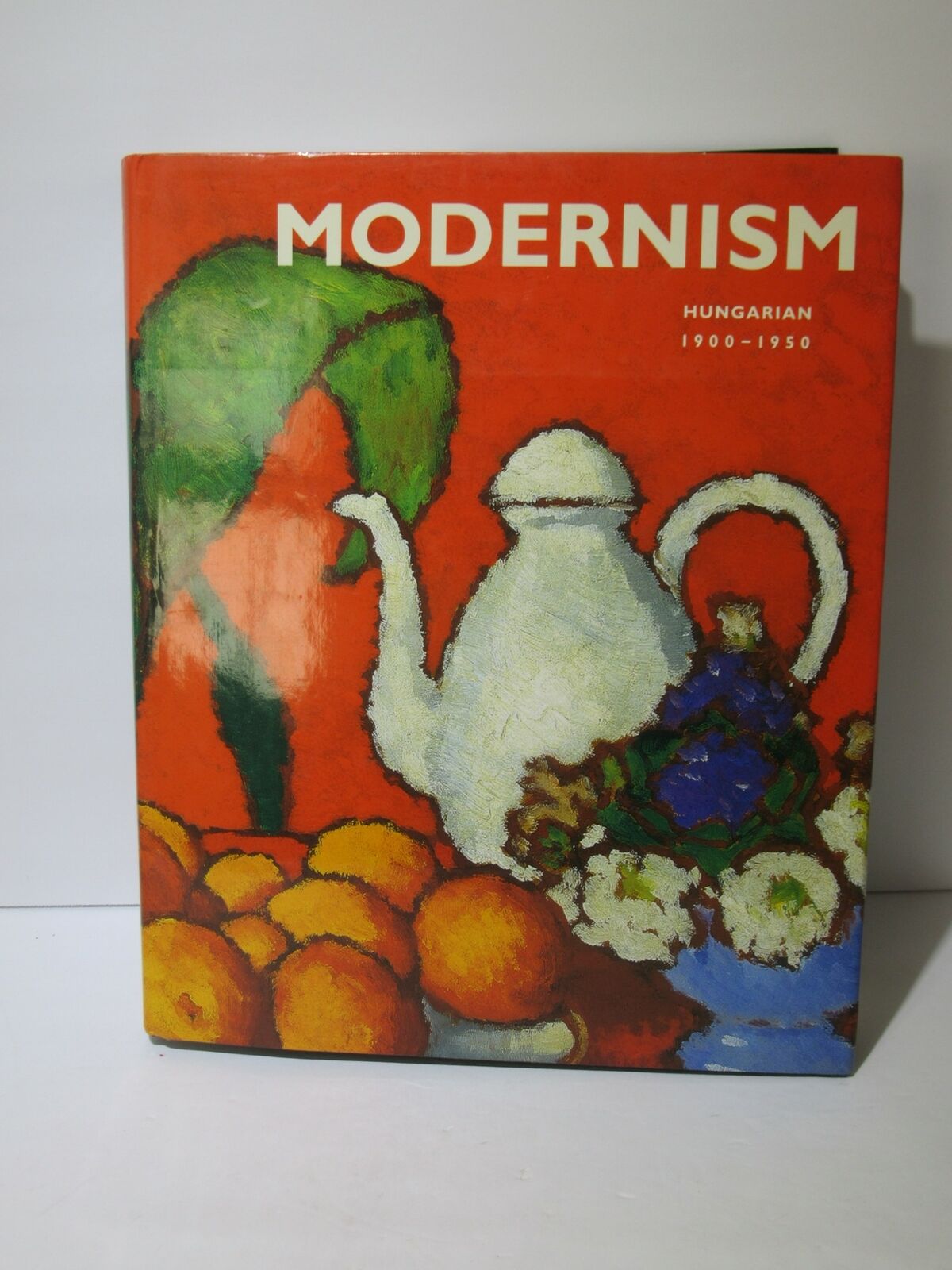 The Keiselbach Collection Modernism Hungarian 1900-1950 by Tamas Keiselbach, showcasing a vibrant cover featuring a white teapot, colorful fruits, and a bold red background, emphasizing the artistic style of Hungarian modernism.