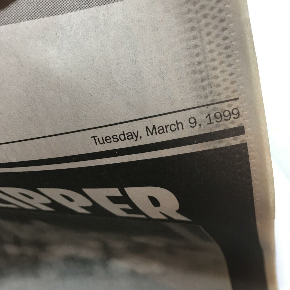 Close-up of the date on the NY Daily News newspaper from March 9, 1999, featuring the title 'Farewell Yankee Clipper Joe Dimaggio 1914-1999.'