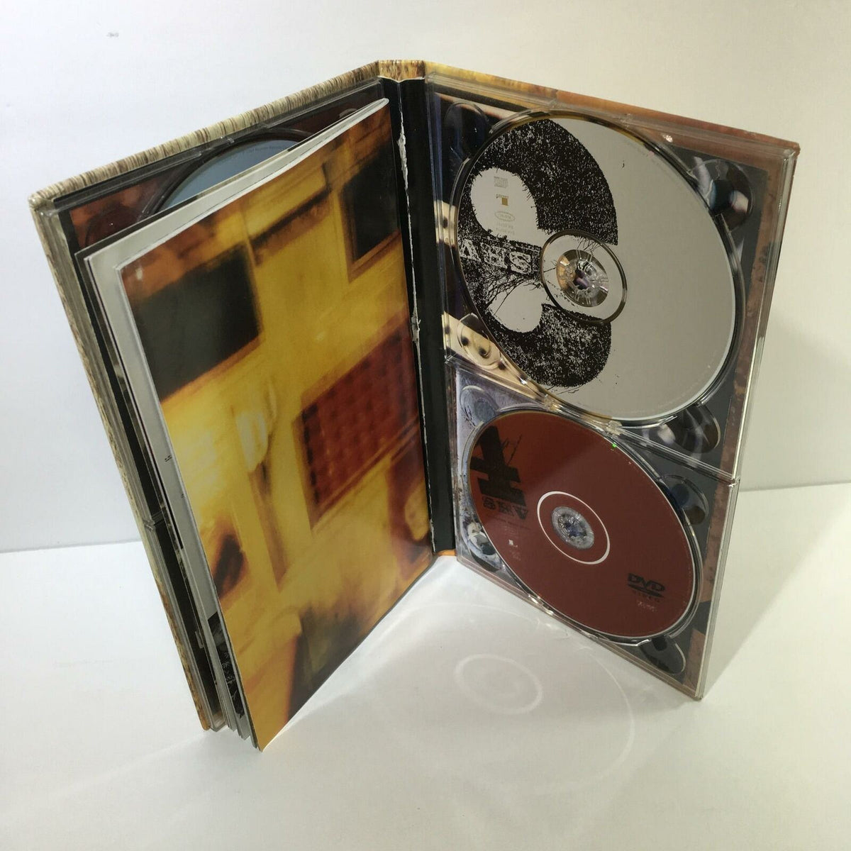 Opened Stevie Ray Vaughan And Double Trouble 4 Disc Box Set Audio CD displaying multiple discs in case.