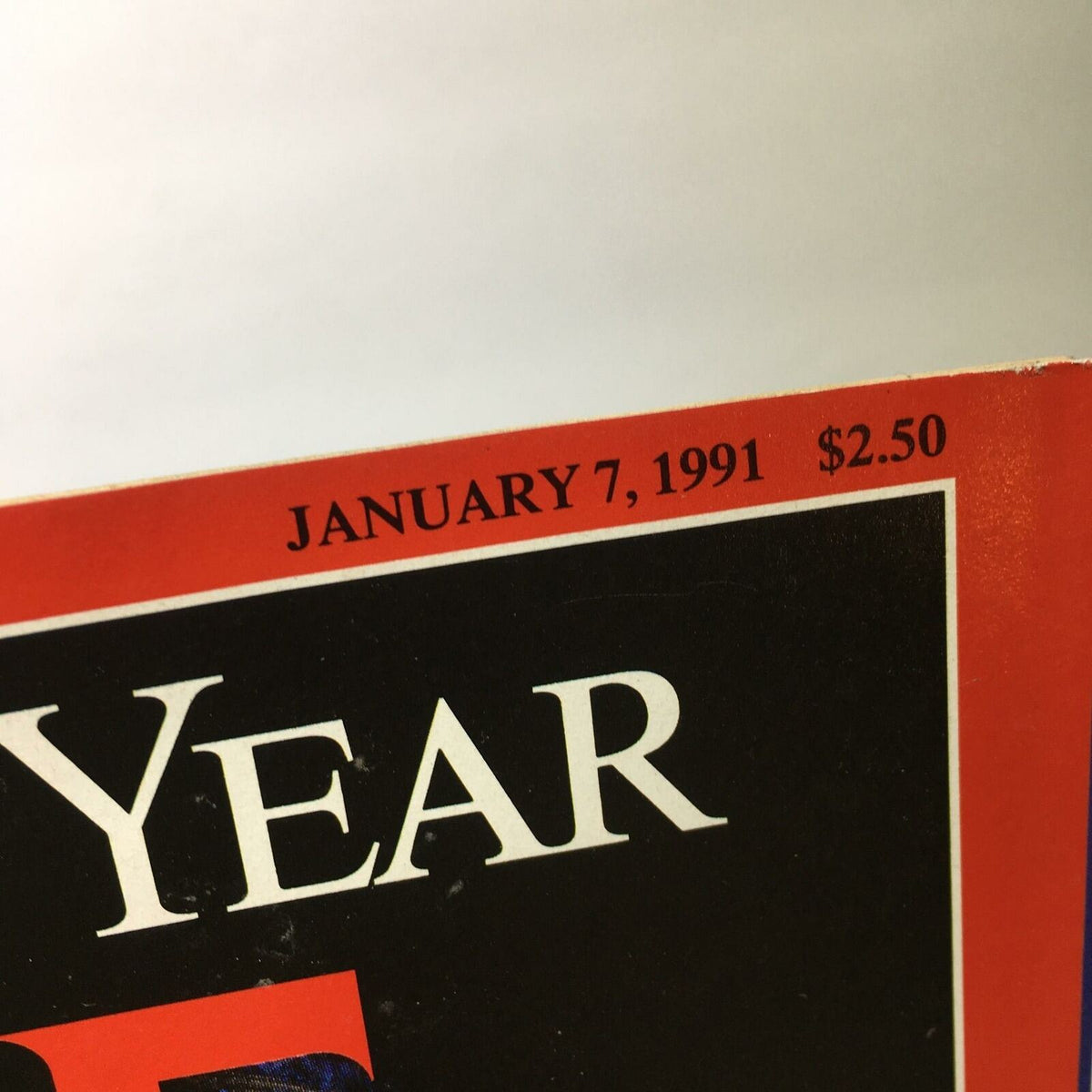 Close-up of the publication date and price on the cover of Time Magazine, January 7, 1991, featuring 'The Two George Bushes' as Men of the Year, priced at $2.50.