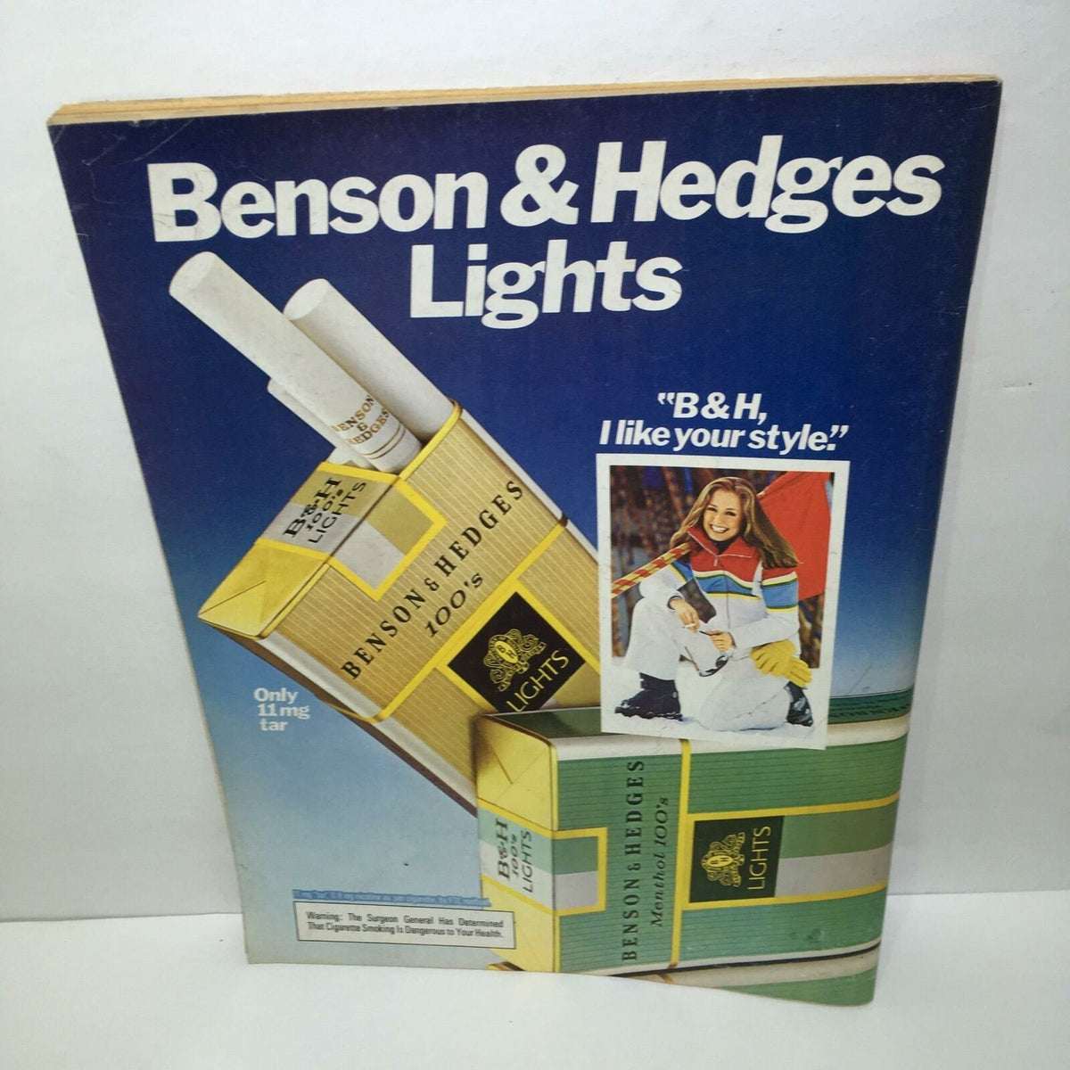 Vintage advertisement for Benson & Hedges Lights cigarettes displayed in a magazine, highlighting the slogan 'B&H, I like your style' from a Time Magazine issue.
