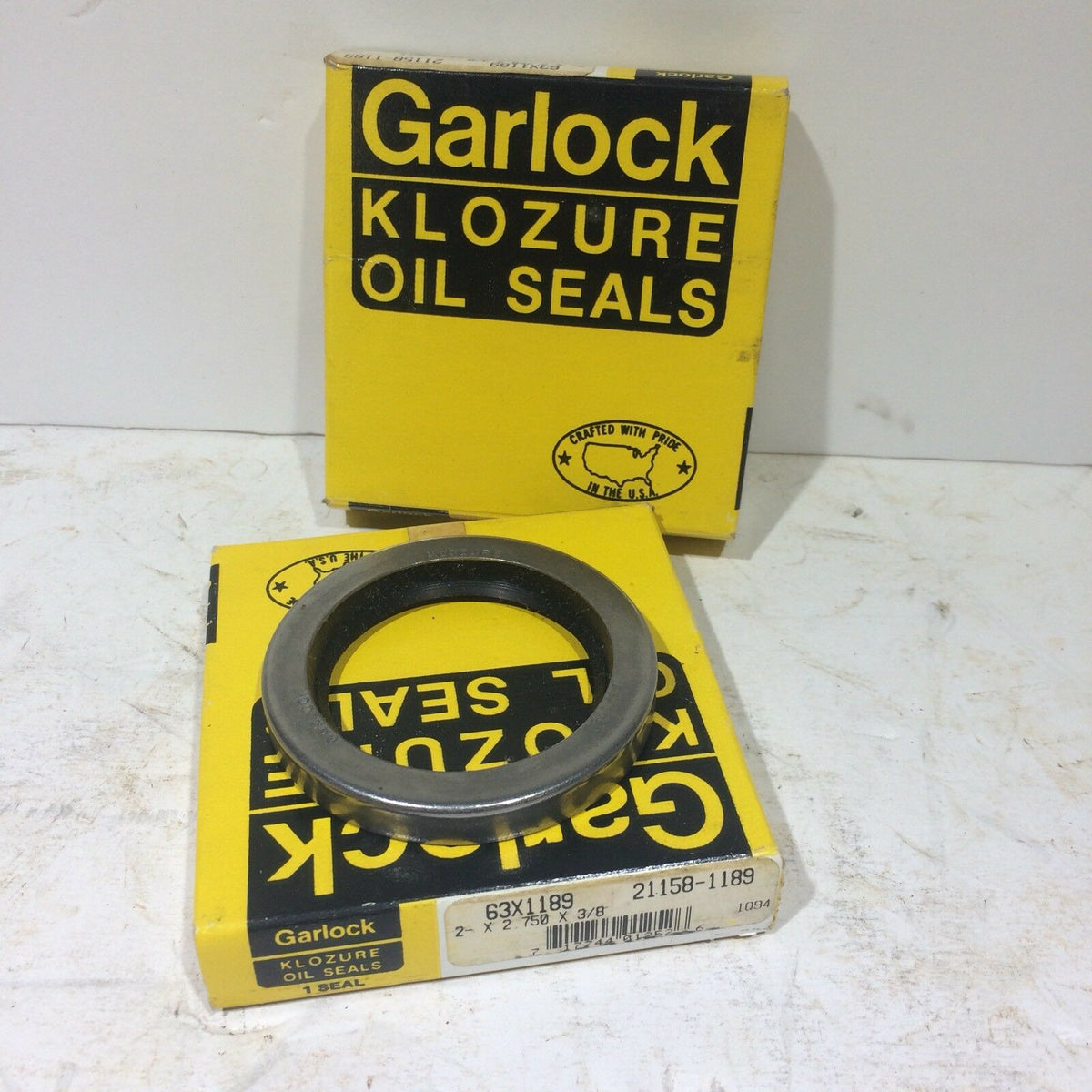 GARLOCK KLOZURE 63X1189 21158-1189 Oil Seal displayed in its packaging, highlighting the robust and durable design, ideal for machinery repair and automotive maintenance.