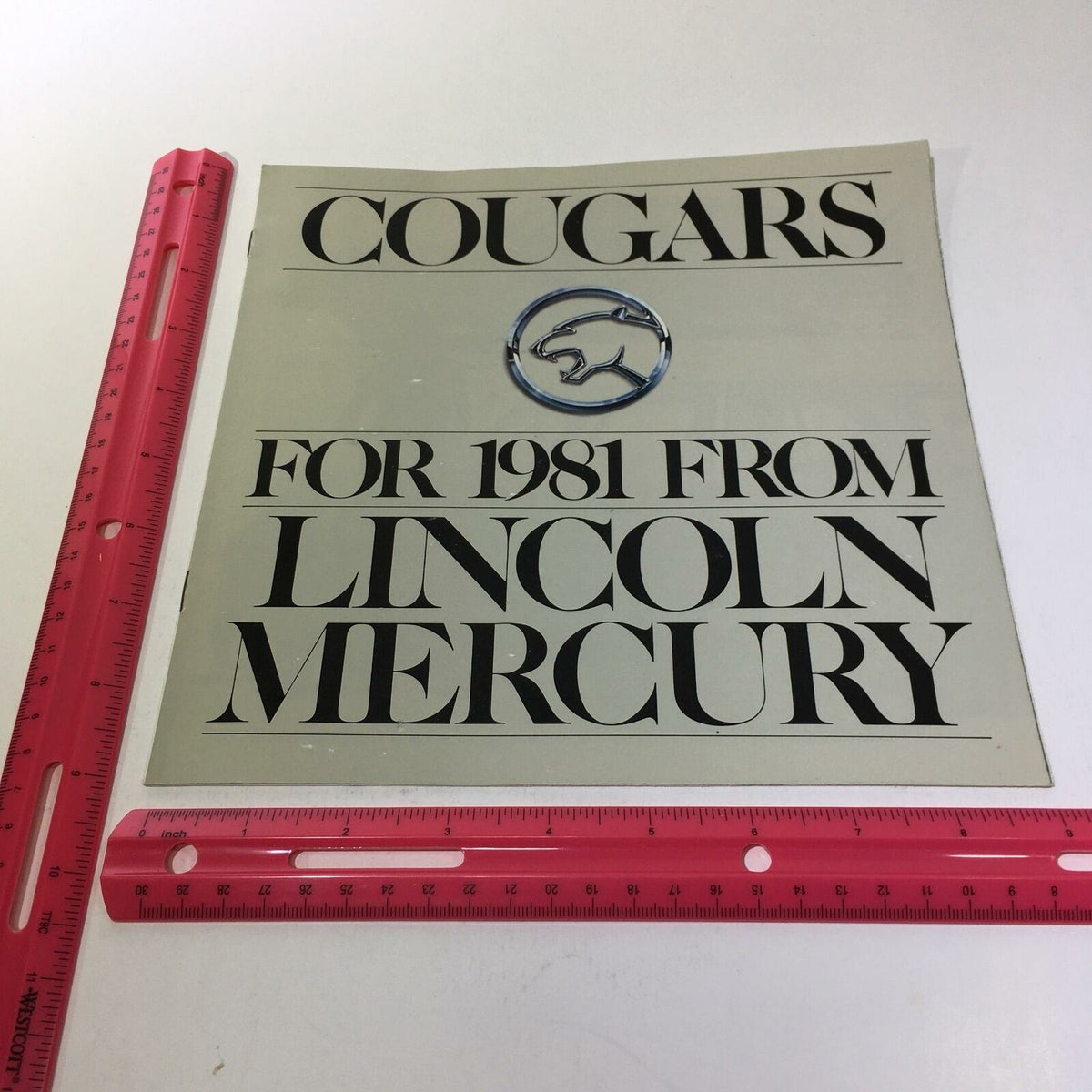 Front cover of the 1981 Lincoln-Mercury Cougars XR-7 Inspired Sedan brochure featuring the car's logo and title.