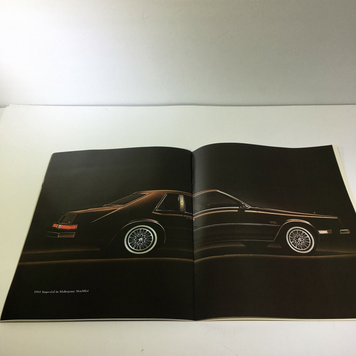 Side view of the 1981 Imperial in Sterling Silver Crystal Coat - Imperial Car Sale Brochure, emphasizing the sleek black exterior and classic design features.