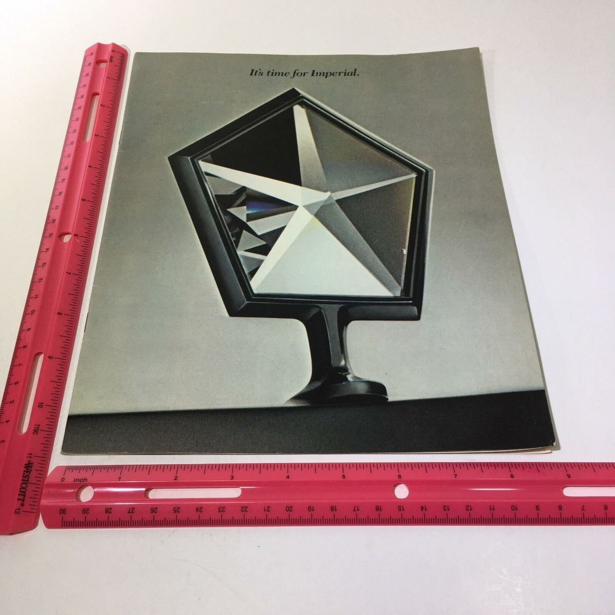 Inside view of the 1981 Imperial in Sterling Silver Crystal Coat - Imperial Car Sale Brochure highlighting the unique crystal design under a ruler for size reference.