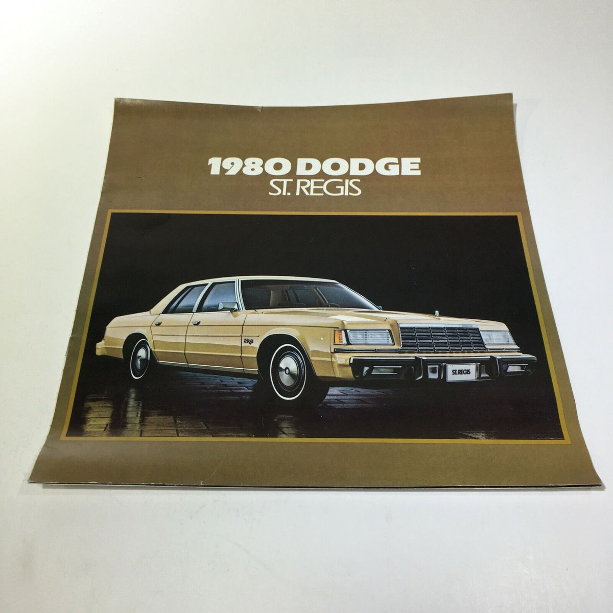 1980 Dodge St. Regis brochure showcasing the exterior design of the vintage car, featuring a gold color scheme and sleek lines, capturing the essence of classic American automobiles.