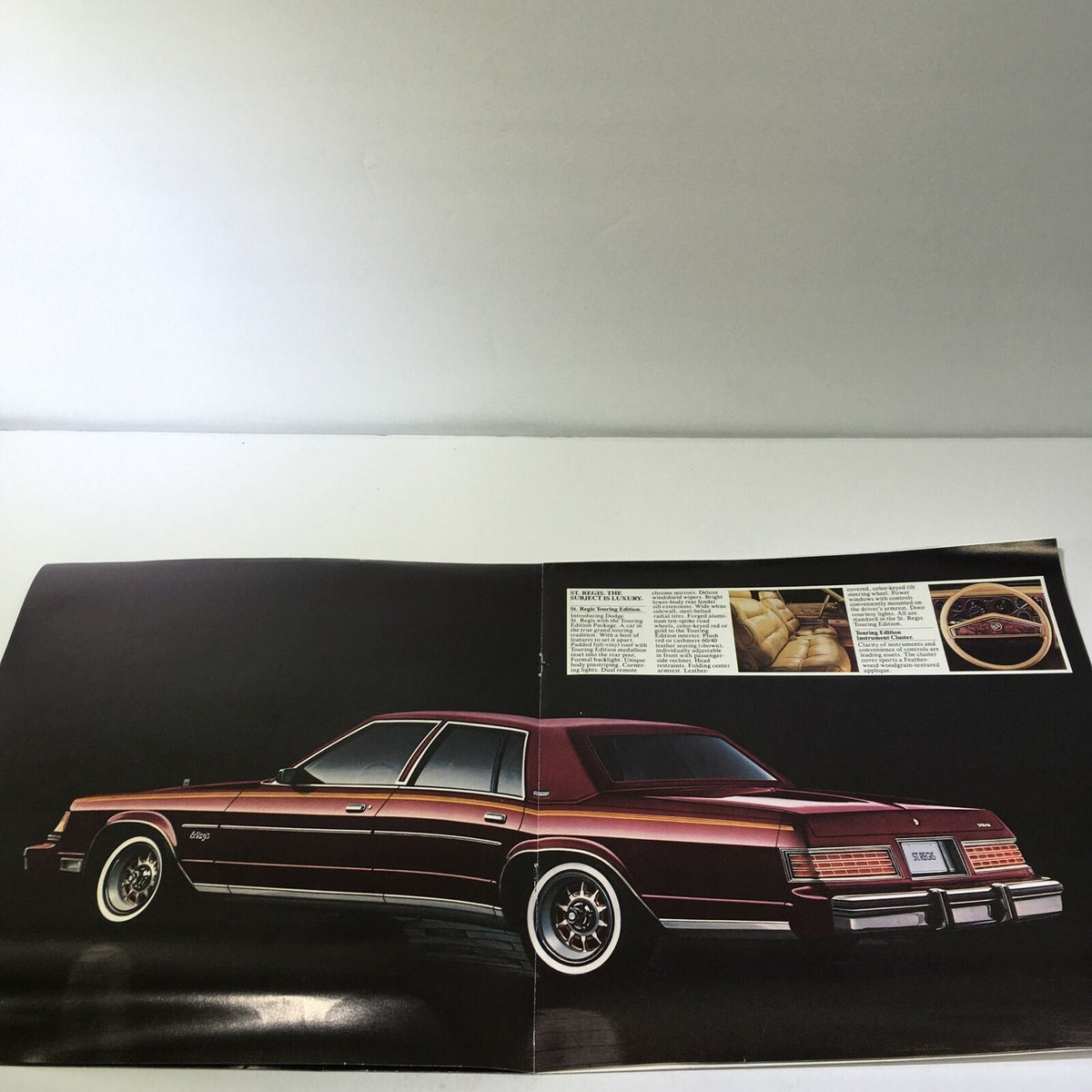 1980 Dodge St. Regis 225 Slant Six Standard V-8 Engine Options Car Brochure showcasing the rear view of the vehicle with a dark background.