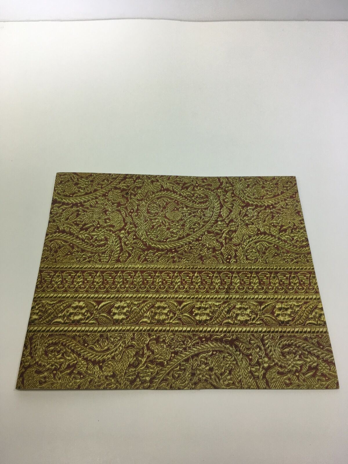 Vintage 1961 Cadillac The Sixty-Two Coupe 8-Cylinder brochure cover featuring ornate golden texture, ideal for automotive collectors.