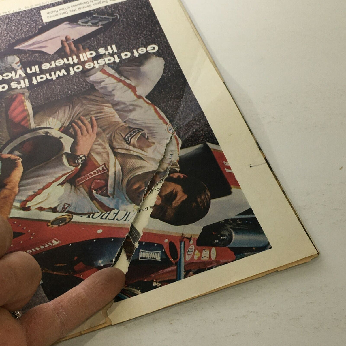 Back cover of Sports Illustrated April 23 1973, featuring an image related to auto racing with visible wear and tear, highlighting its vintage condition.