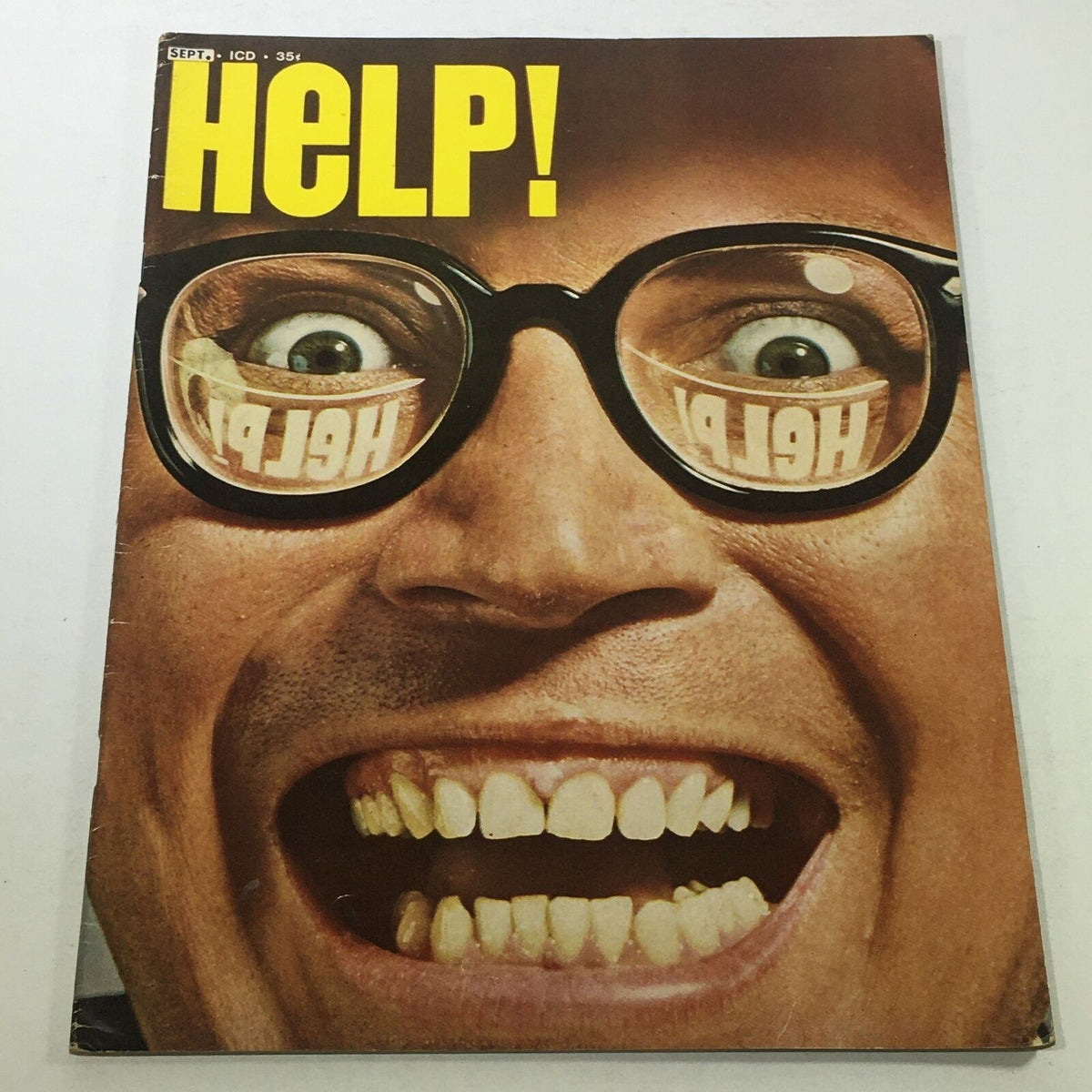 Cover of VTG Help Magazine: September 1961 Vol. 1 No. 12 featuring a humorous illustration of a man with glasses and a big smile, showcasing the vintage style of mid-century publishing.