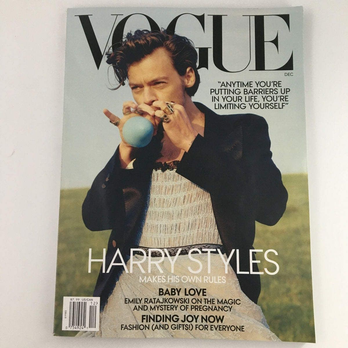 Vogue Magazine December 2020 issue featuring Harry Styles on the cover in a striking 'Playtime' theme. The magazine showcases Harry in a unique fashion ensemble, embodying contemporary style and cultural relevance.