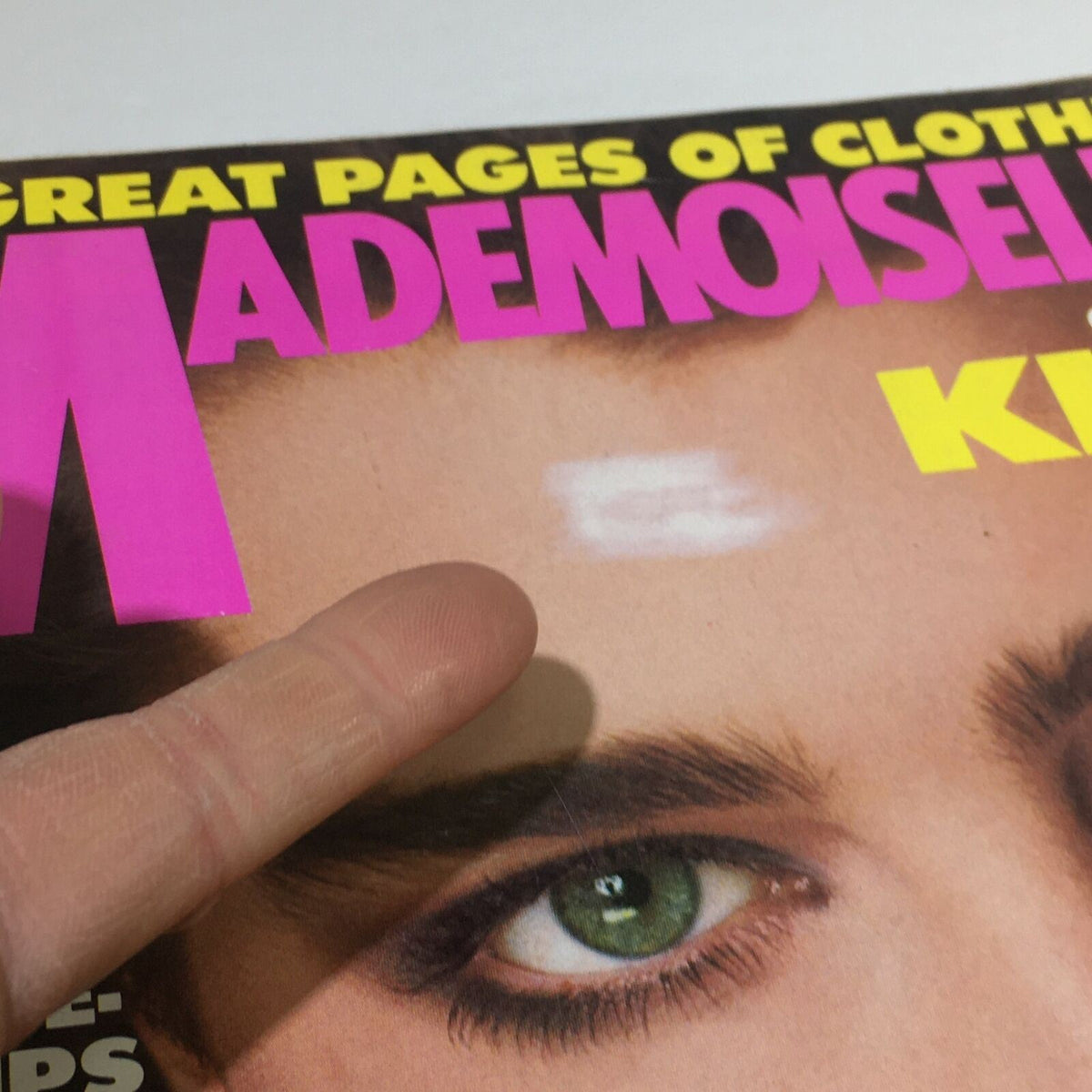 VTG Mademoiselle Magazine: July 1983 - Brooke Shields Fashion Cover with a finger pointing at a light mark on the magazine, indicating signs of wear on the iconic cover.