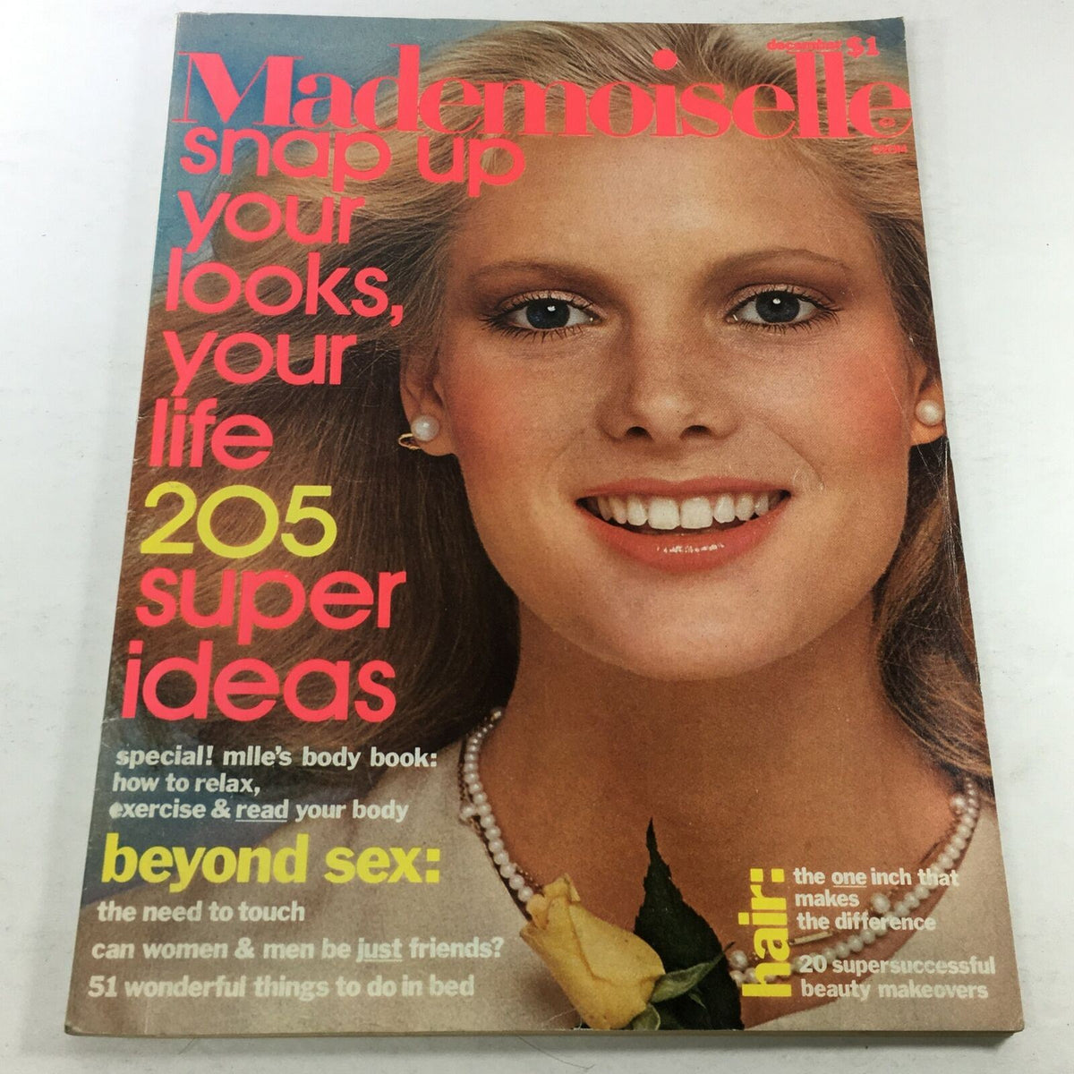 Vintage Mademoiselle Magazine cover from December 1975 featuring captivating cover model Lisa Cooper. The cover includes vibrant text urging readers to 'snap up your looks, your life' with 205 super ideas, alongside promotional content highlighting topics like relaxation, hair makeovers, and articles on relationships. This magazine is a collector's item reflecting 1970s fashion and cultural insights.