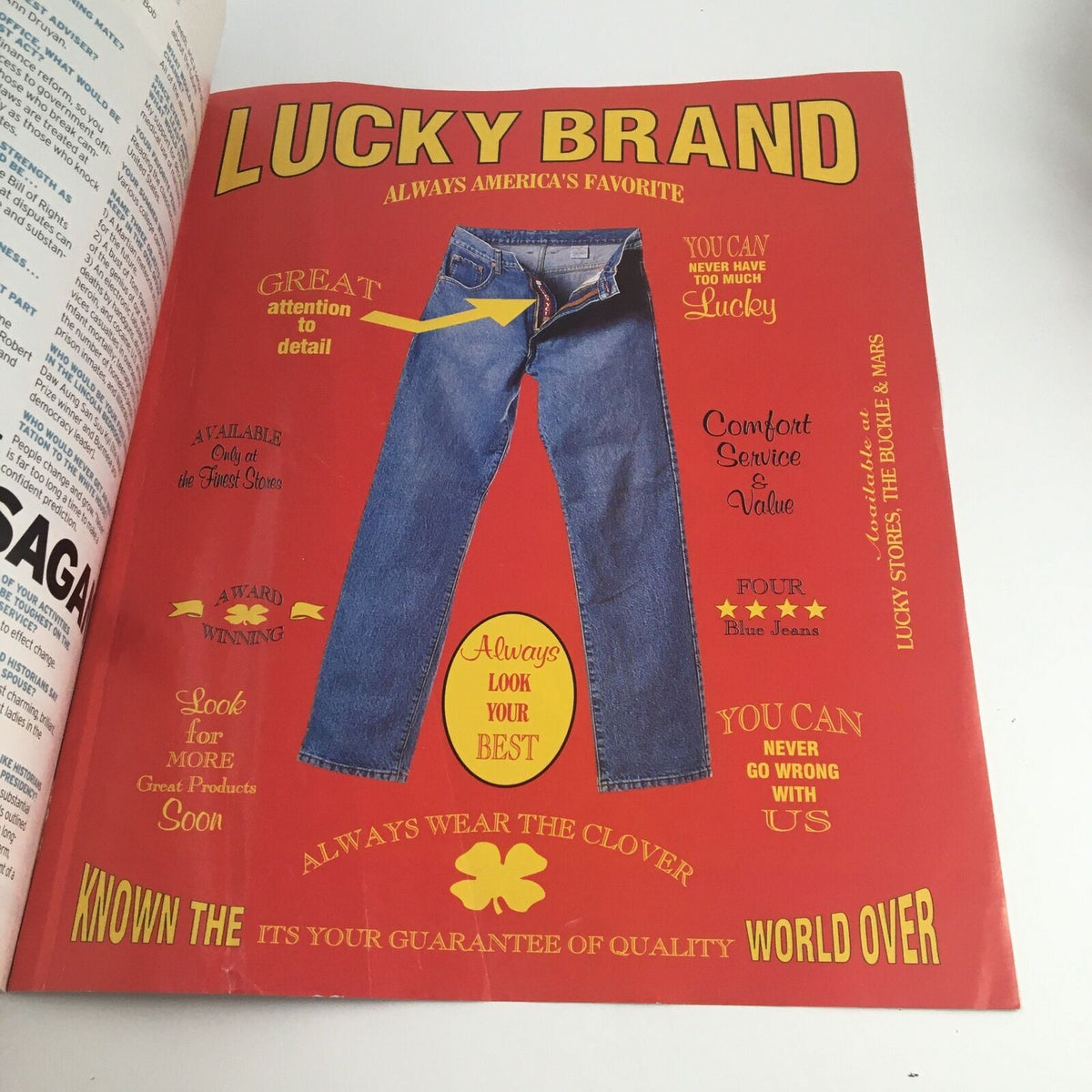 Ad page in George Magazine February 1997 showcasing Lucky Brand jeans with vivid graphics and marketing text.