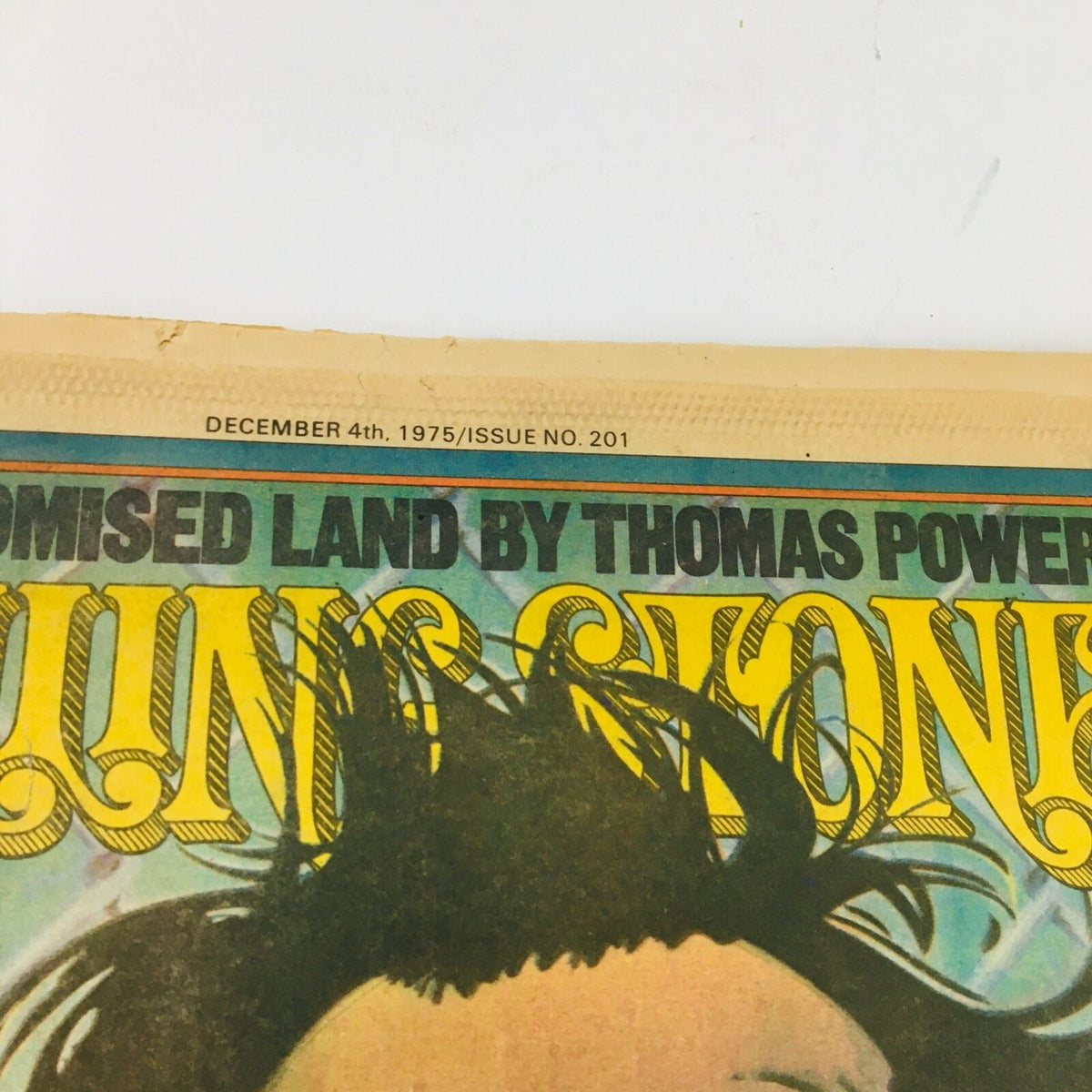 A top view of the Rolling Stone Magazine December 4, 1975, marking the date and issue number, capturing the essence of collectible music history with issue #201.