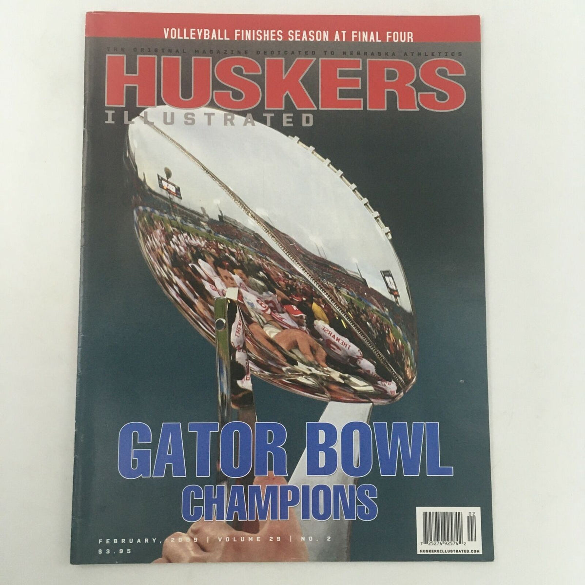 Huskers Illustrated February 2009 Vol 29 #2 Gator Bowl Champions Feature magazine cover showcasing a reflective trophy and fans celebrating Nebraska's victory.