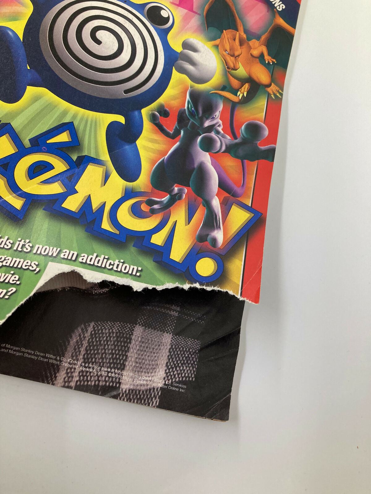 Close-up view of Time Magazine cover from November 22, 1999, showcasing Pokemon characters with a torn corner, focusing on the question of Pokemon's influence on kids.