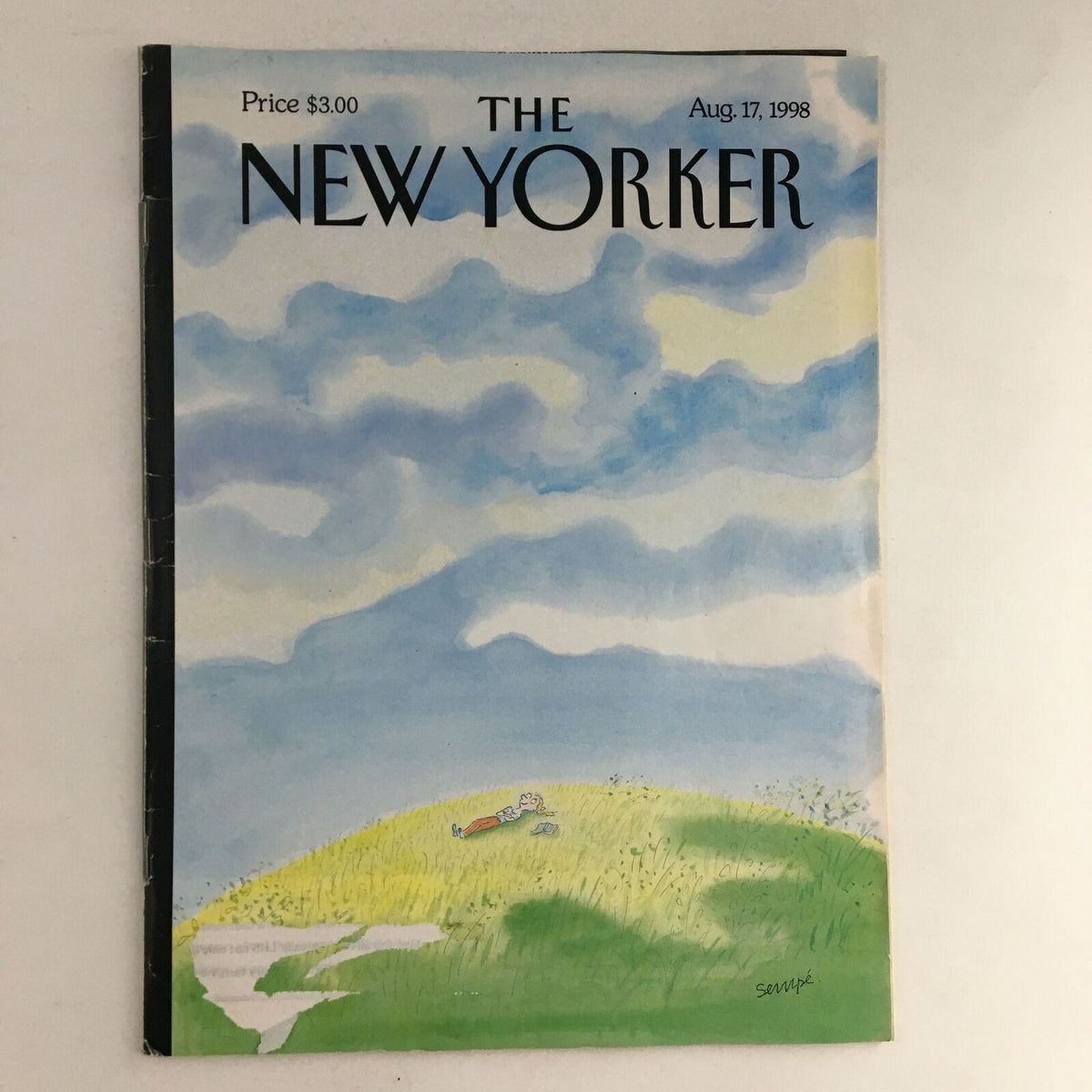 Cover of The New Yorker Magazine August 17 1998 featuring whimsical art by Jean-Jacques Sempé, depicting a serene landscape with a character lying on a hill under a cloudy sky.