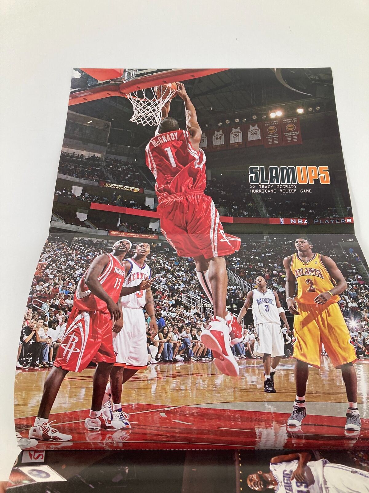 Slam Magazine December 2005 featuring a dynamic action shot of LeBron James dunking during a game, showcasing the excitement of NBA basketball.