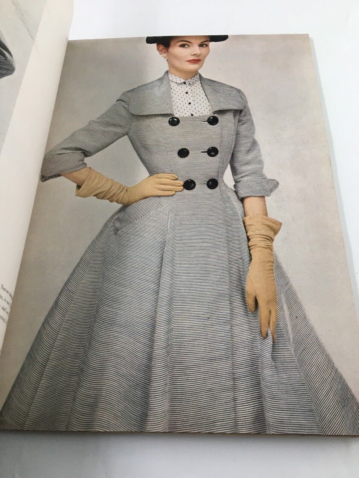 Fashion illustration in Harper's Bazaar March 1952 depicting a woman in a stylish striped dress and gloves, representing 1950s fashion.