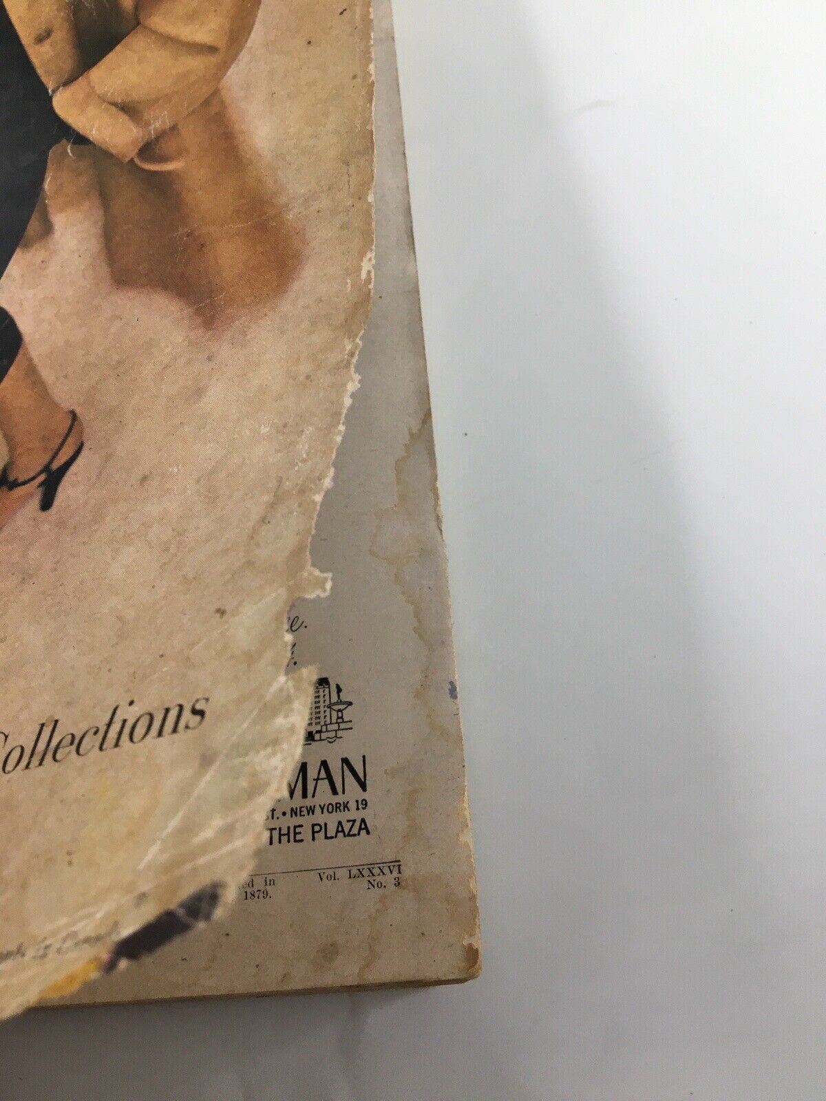 Close-up of the March 1952 Harper's Bazaar magazine spine, revealing the 'Collections' title and signs of age, emphasizing the magazine’s vintage appeal for fashion collectors.