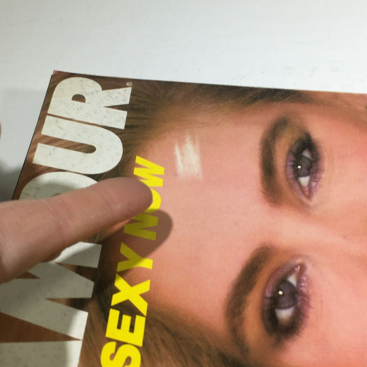 Close-up view of the Vintage Glamour Magazine November 1980 cover, highlighting the text 'What's Sexy Now' with a focus on the model Kelly Emberg's expressive features.