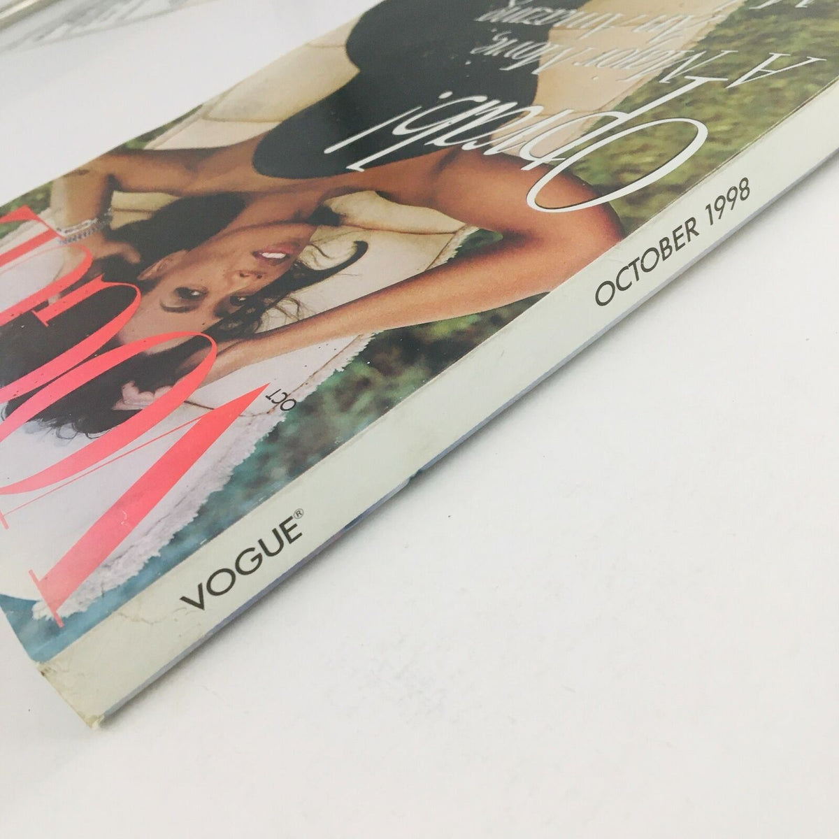 Side view of Vogue Magazine October 1998 with Oprah Winfrey on the cover, highlighting the title and publication date, offering a glimpse into its vintage aesthetic.