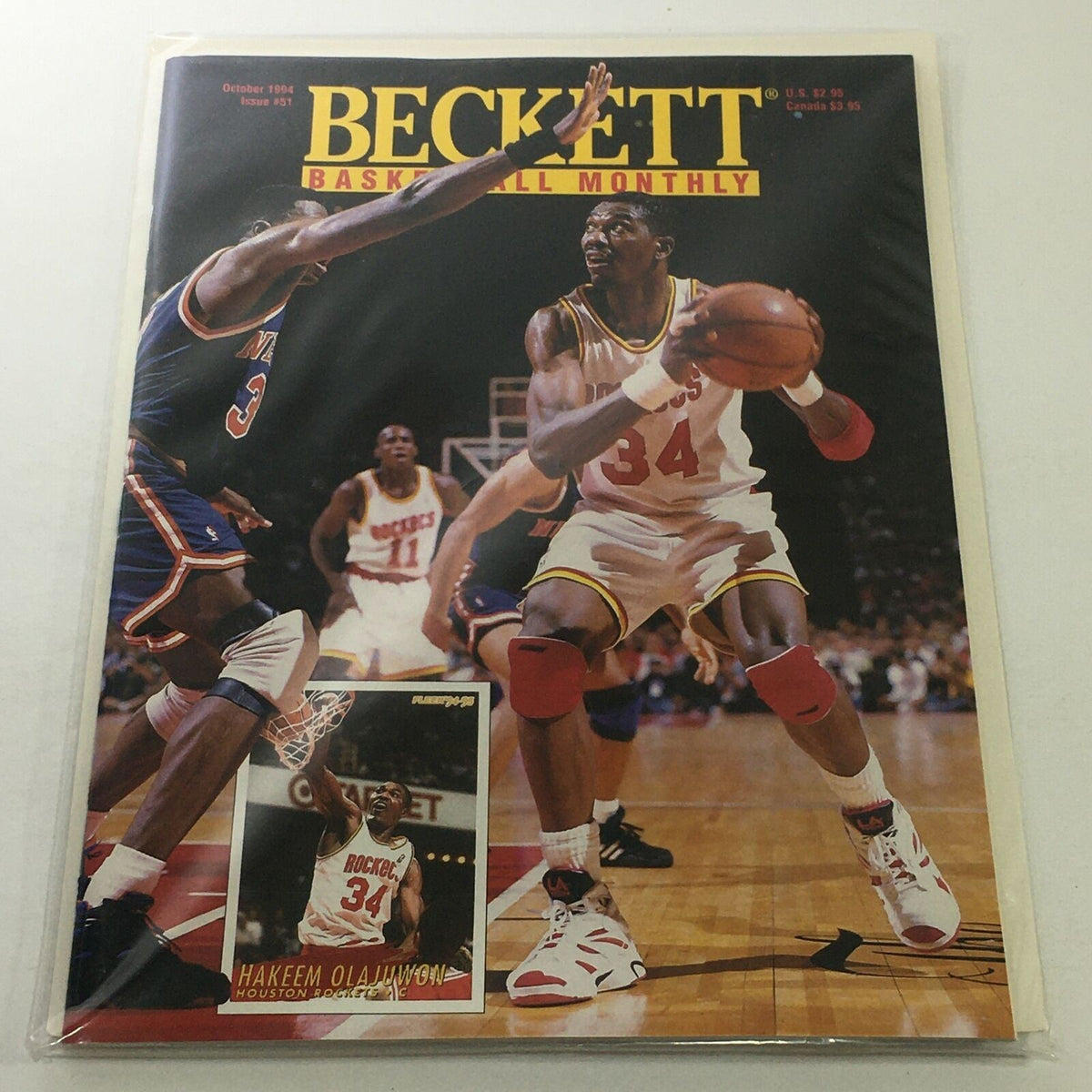 Beckett Basketball Monthly: October 1994 Issue #51 featuring Hakeem Olajuwon in action on the cover, showcasing basketball gameplay with vibrant photography.