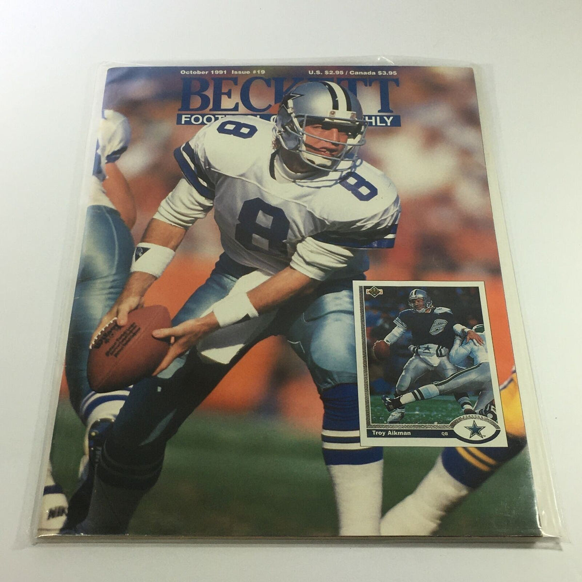 Beckett Hockey Monthly: October 1991 Issue #19 featuring Troy Kenneth Aikman on the cover, showcasing a football player in action. The magazine is in excellent condition and bagged for protection.