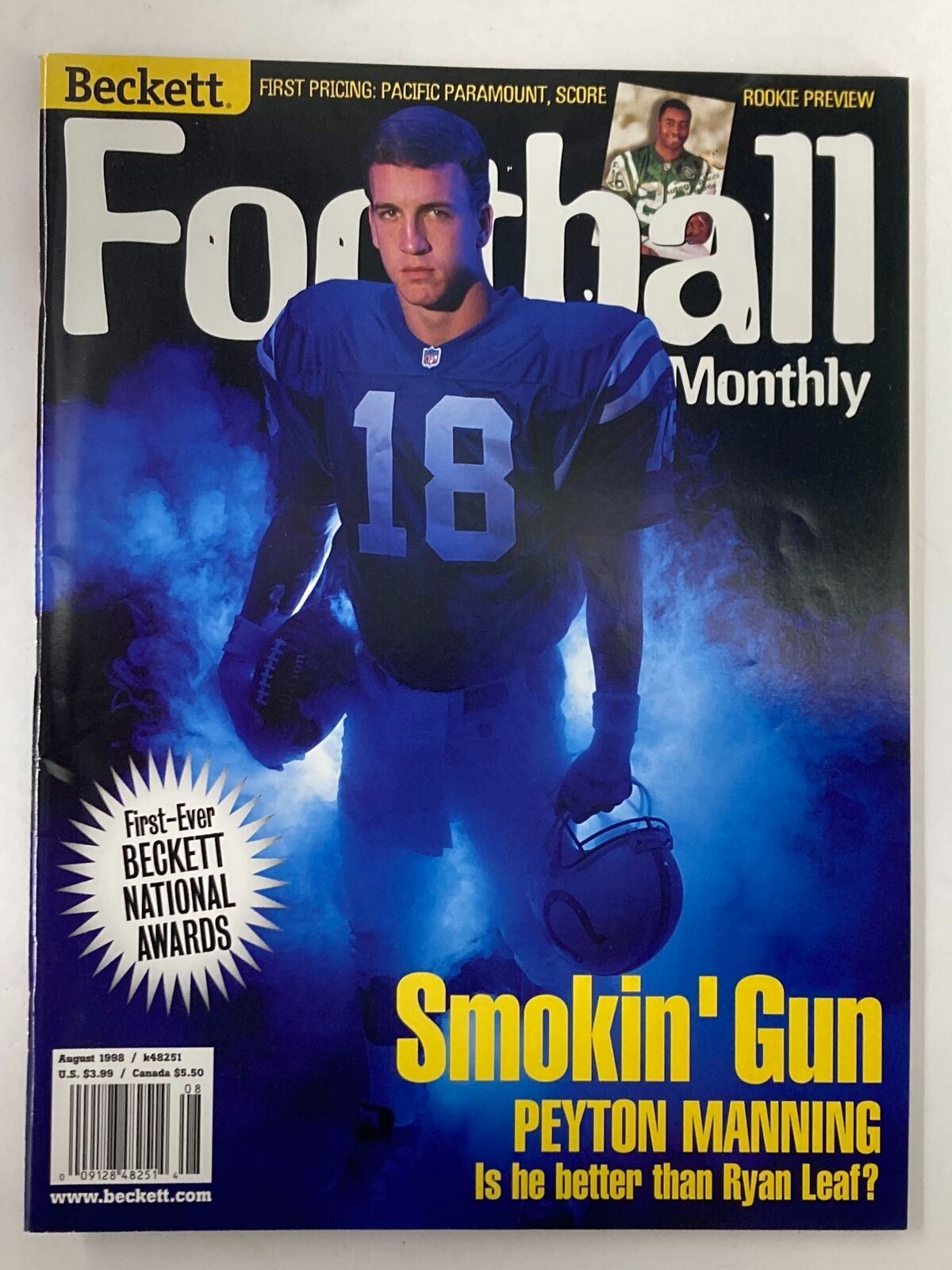 Beckett Football Card Monthly August 1998 Issue 101 featuring Peyton Manning on the cover, showcasing him in a blue jersey with the title 'Smokin' Gun'. The magazine discusses whether Manning is better than Ryan Leaf.