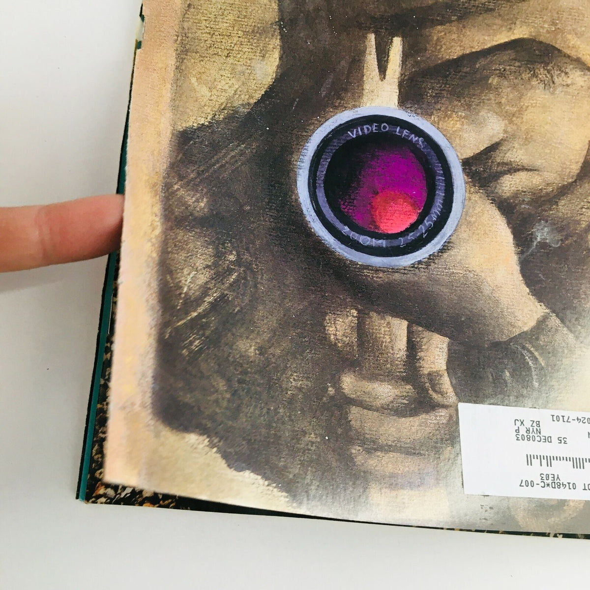 Close-up view of The New Yorker April 14 2003 magazine cover by Ana Juan, highlighting the detailed artwork of a person with a video lens and subtle textures.