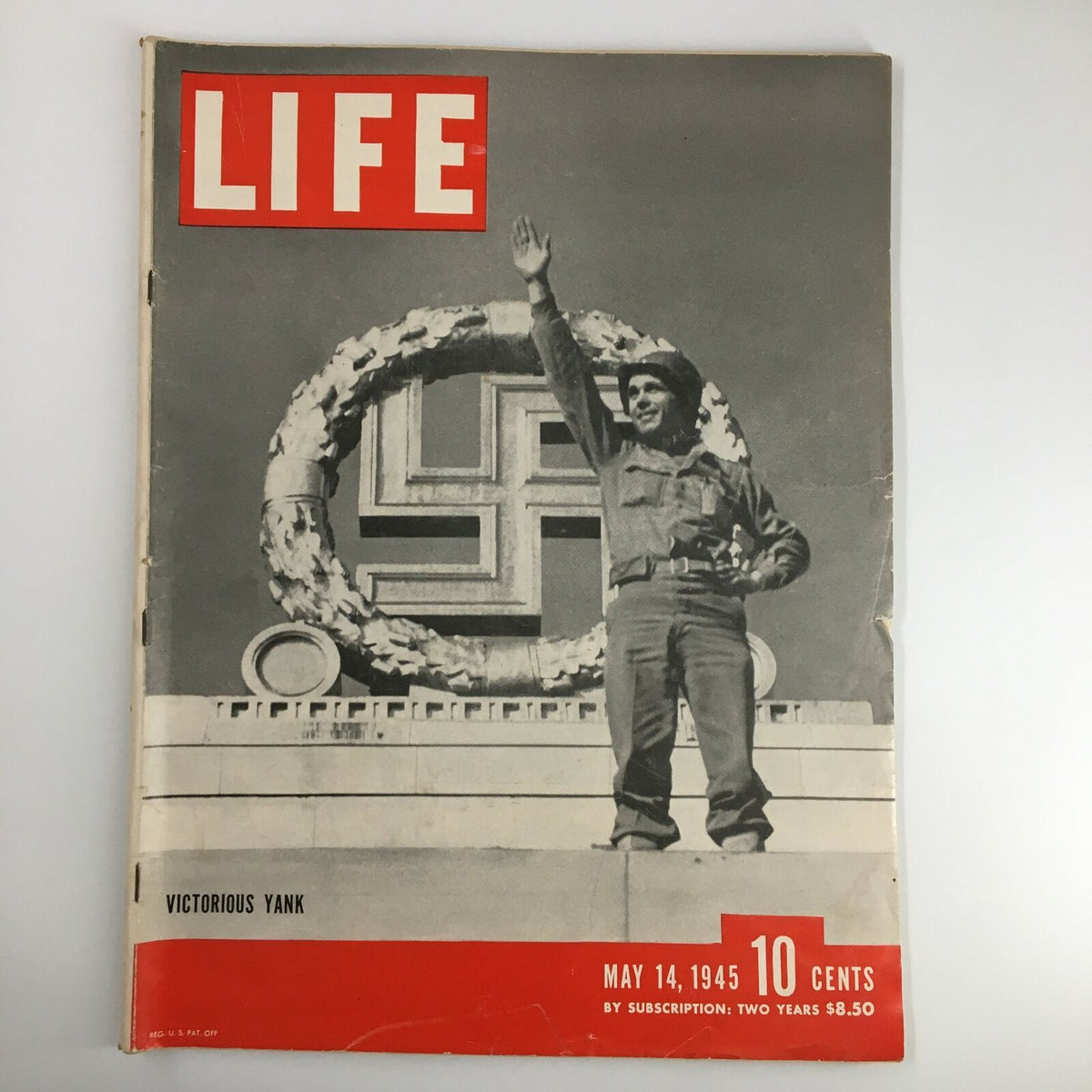 Cover of VTG Life Magazine dated May 14, 1945, featuring a soldier waving, symbolizing the Mass Surrender of Germans during World War II. The cover includes the title 'LIFE' in bold red letters.