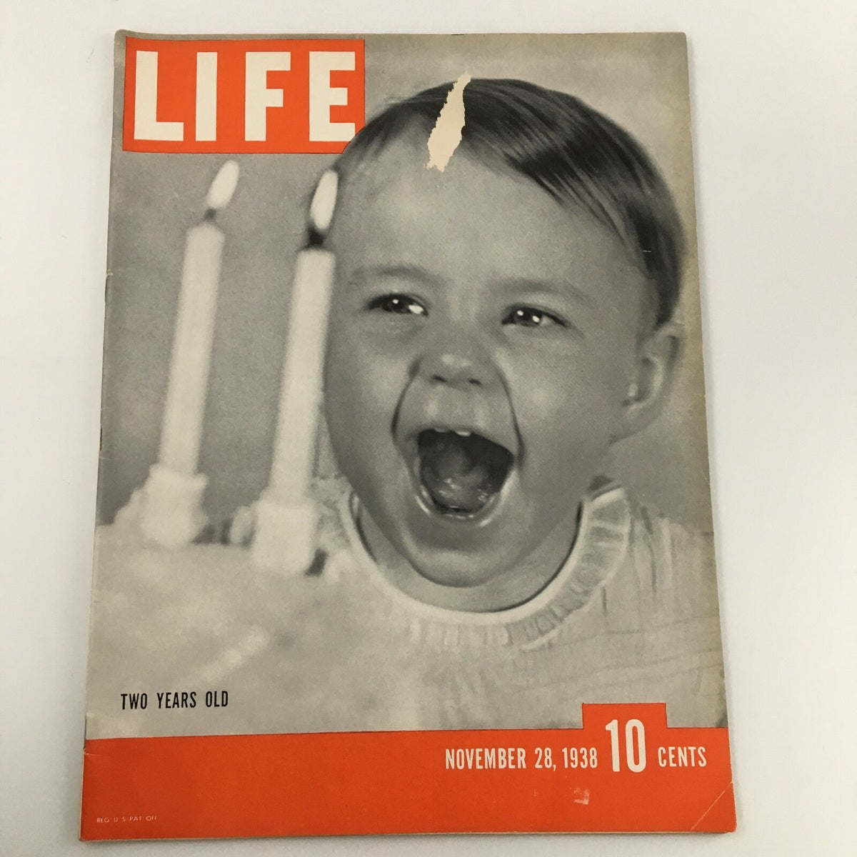 Cover of VTG Life Magazine from November 28, 1938, featuring a joyful child amidst birthday candles, marking two years of publication.