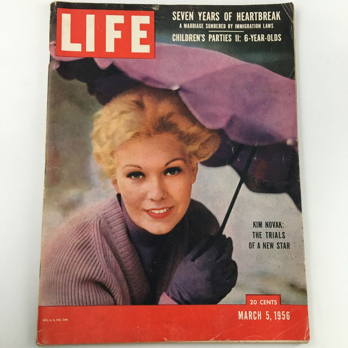 Vintage Life Magazine dated March 5, 1956 featuring Kim Novak on the cover, showcasing her elegant portrait with a purple umbrella. Ideal for collectors of historical magazines and Hollywood memorabilia.