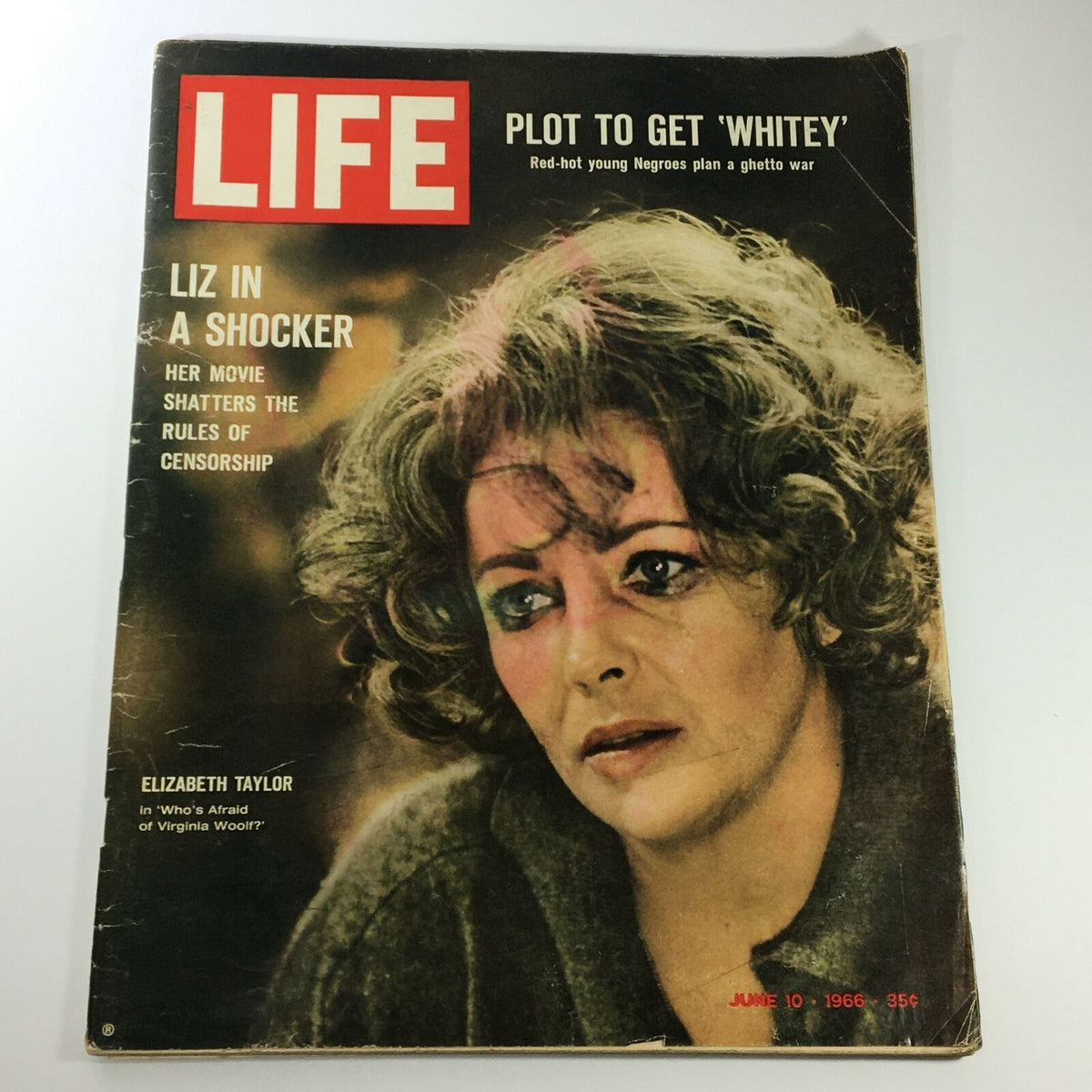Cover of VTG Life Magazine from June 10, 1966, featuring Elizabeth Taylor. The image shows Taylor with dramatic makeup and curly hair, positioned against a colorful background. Title text states 'LIZ IN A SHOCKER' highlighting her role in 'Who's Afraid of Virginia Woolf?'.