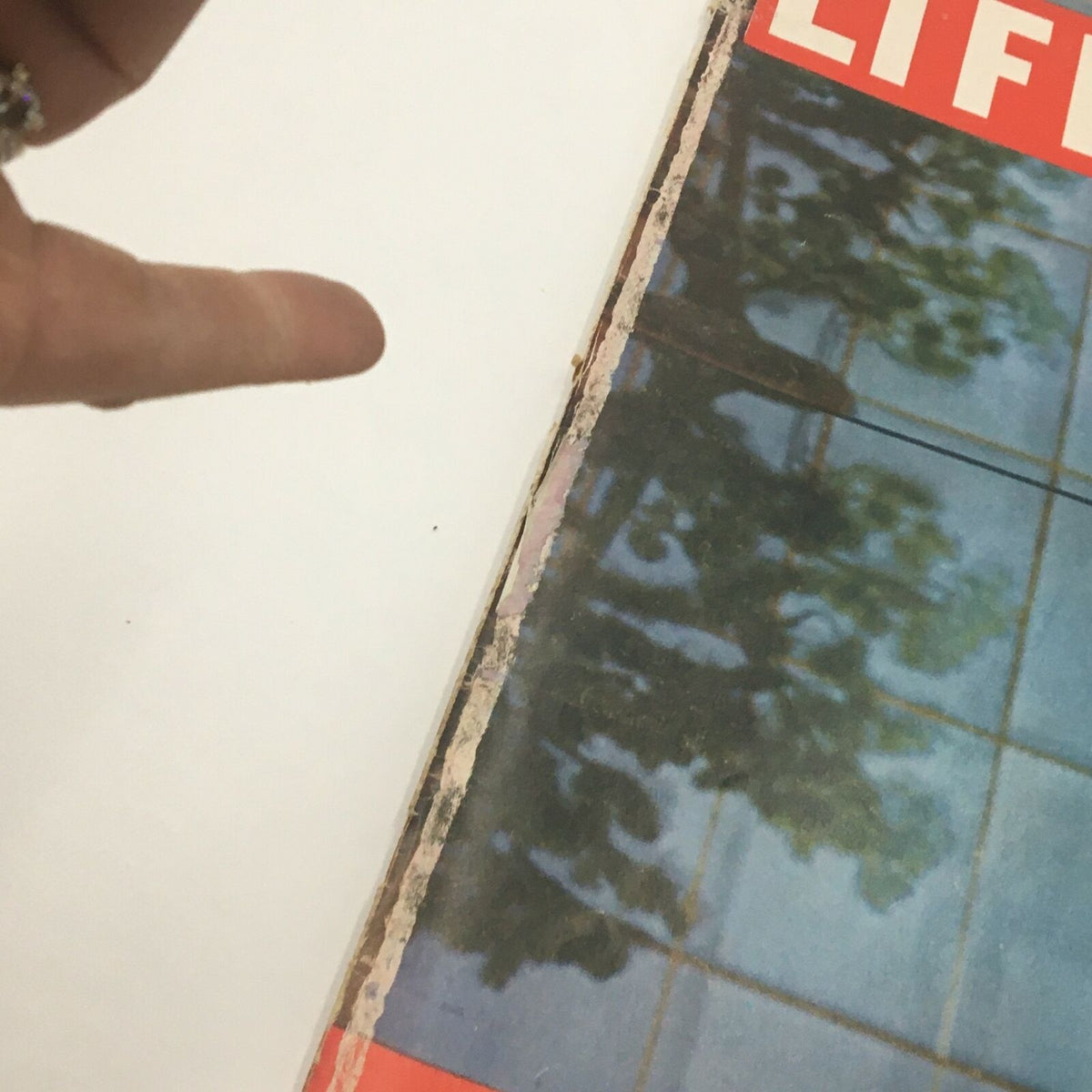 Close-up view of the edge of VTG Life Magazine February 17 1961, highlighting minor wear and features of the vintage publication.